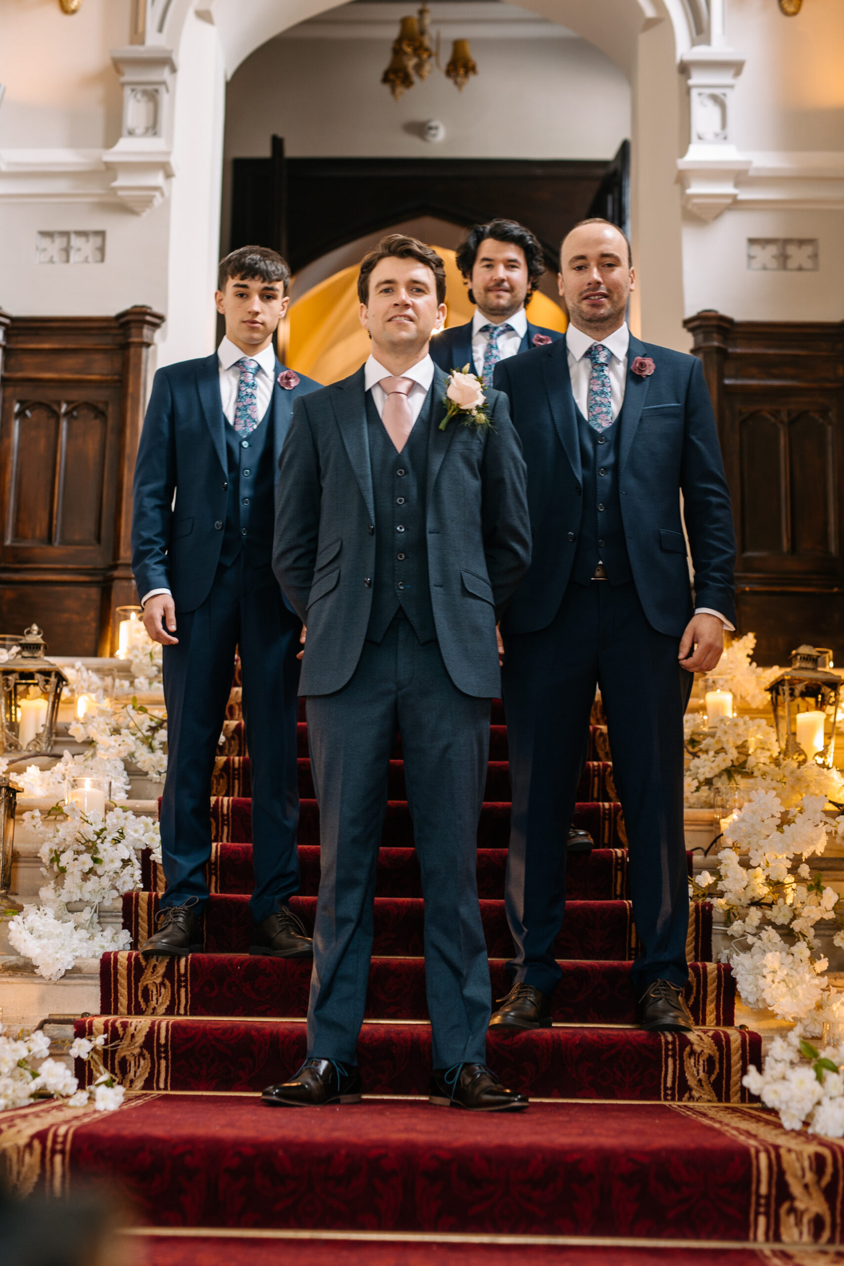 A group of men in suits standing on a staircase