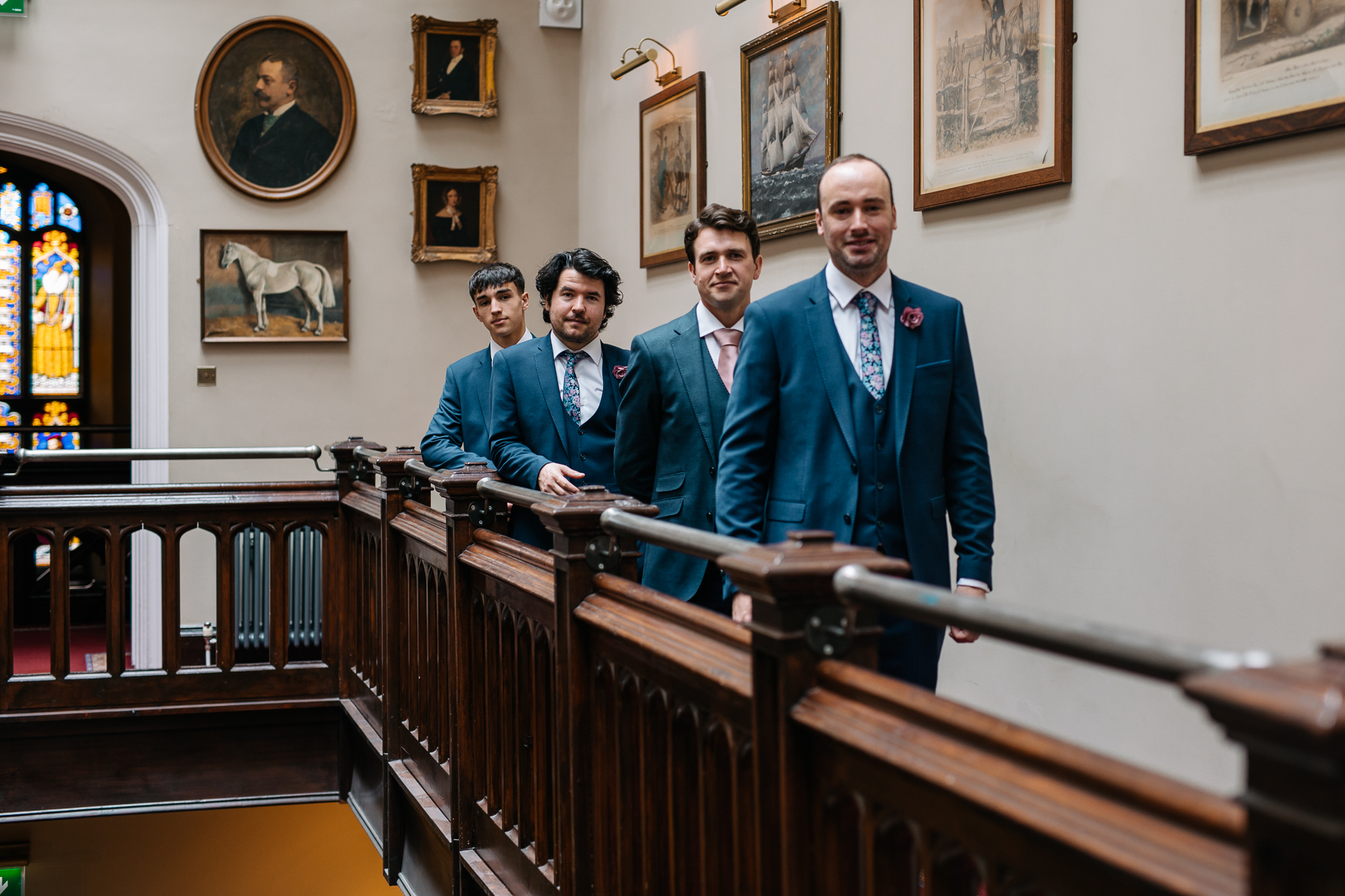 A group of men in suits standing on a staircase