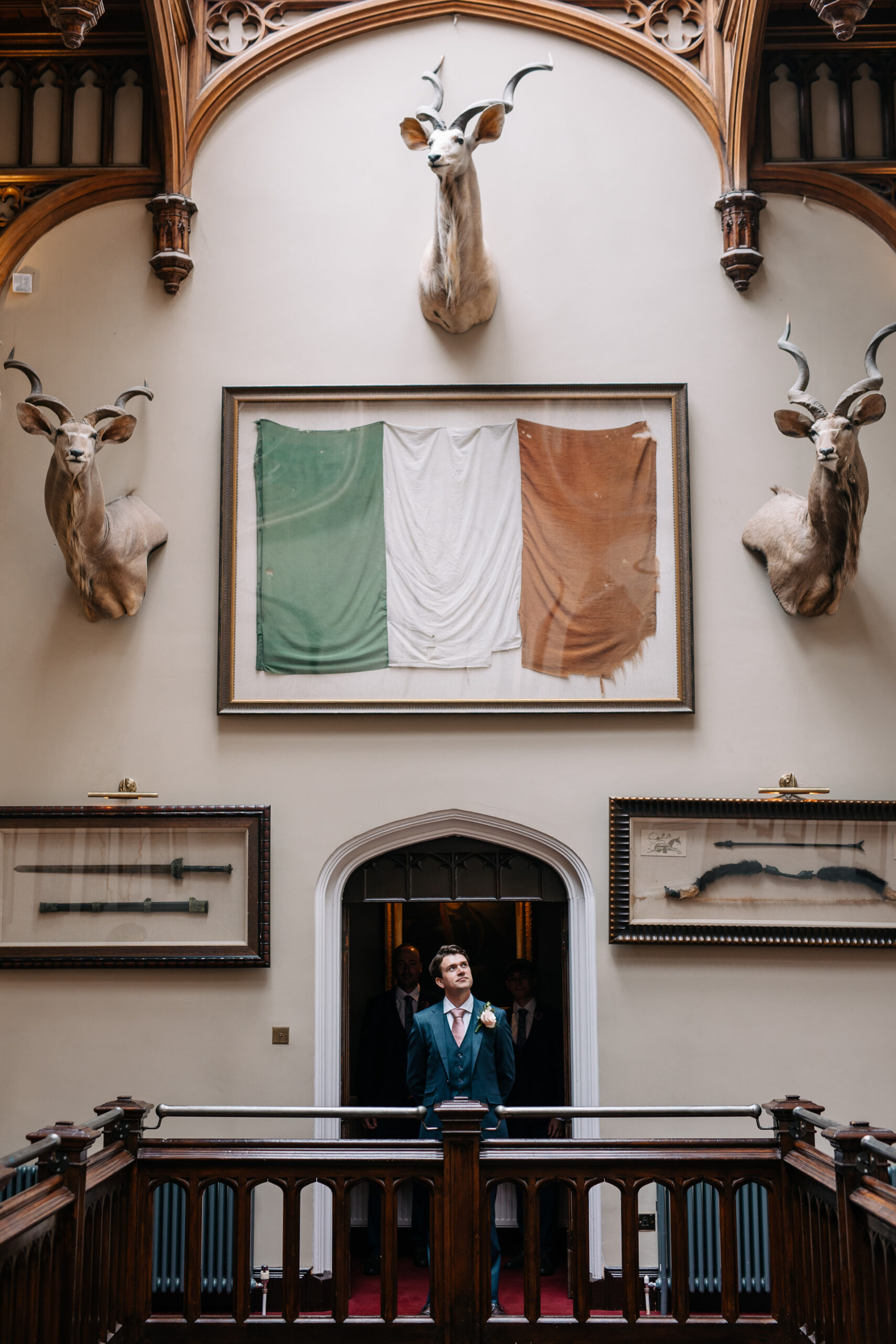 A person standing in a doorway with a painting on the wall