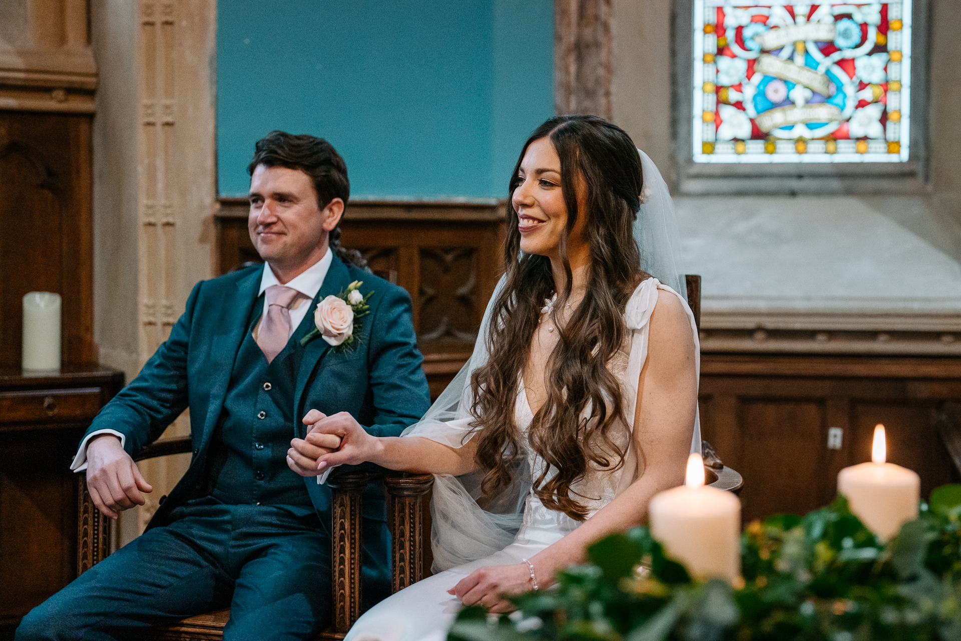 A man and woman sitting at a table with a bouquet of flowers