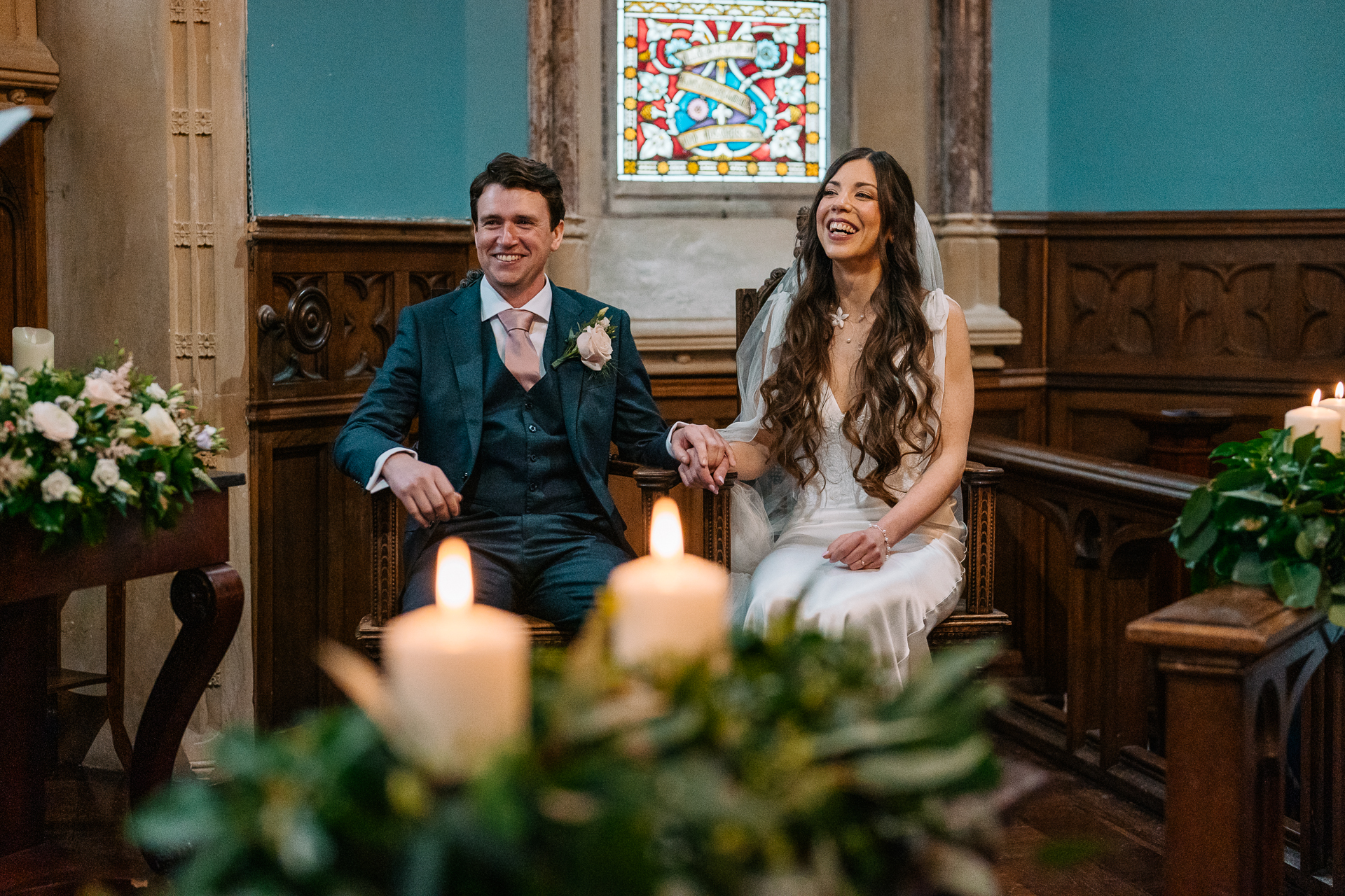 A man and woman posing for a picture with a candle in front of them