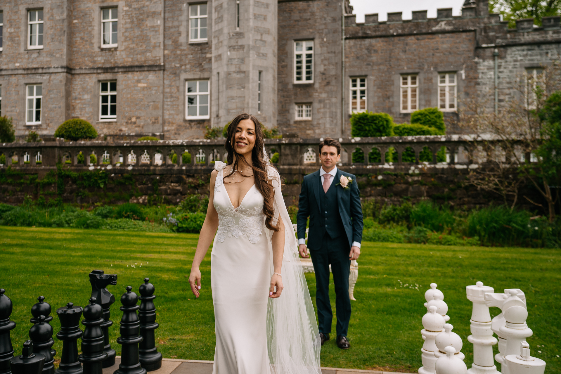 A man and woman posing for a picture in front of a building