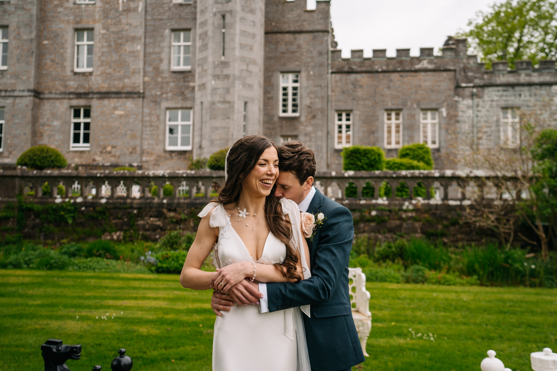 A man and woman posing for a picture in front of a building