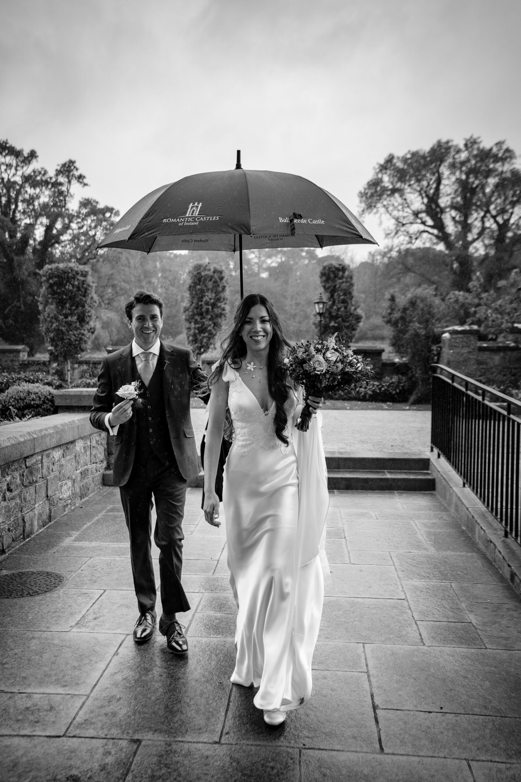 A man and woman walking under an umbrella