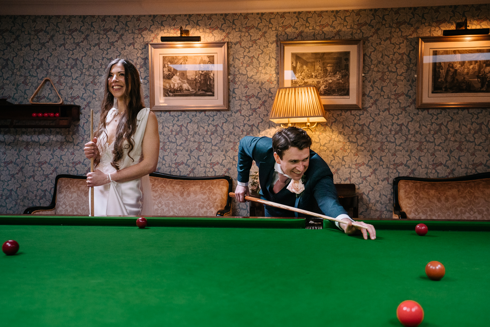 A man and a woman playing pool