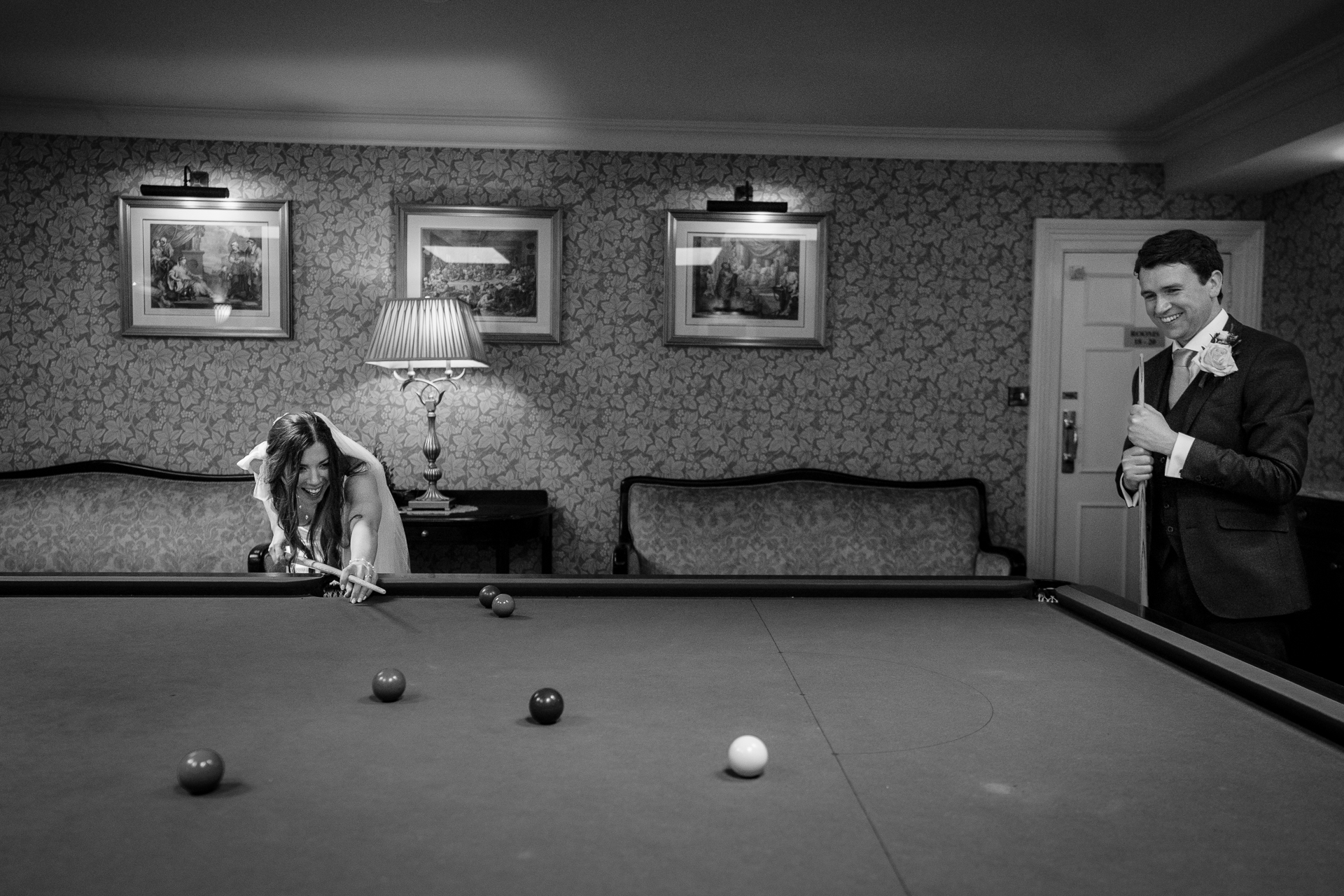 A person and a dog playing pool