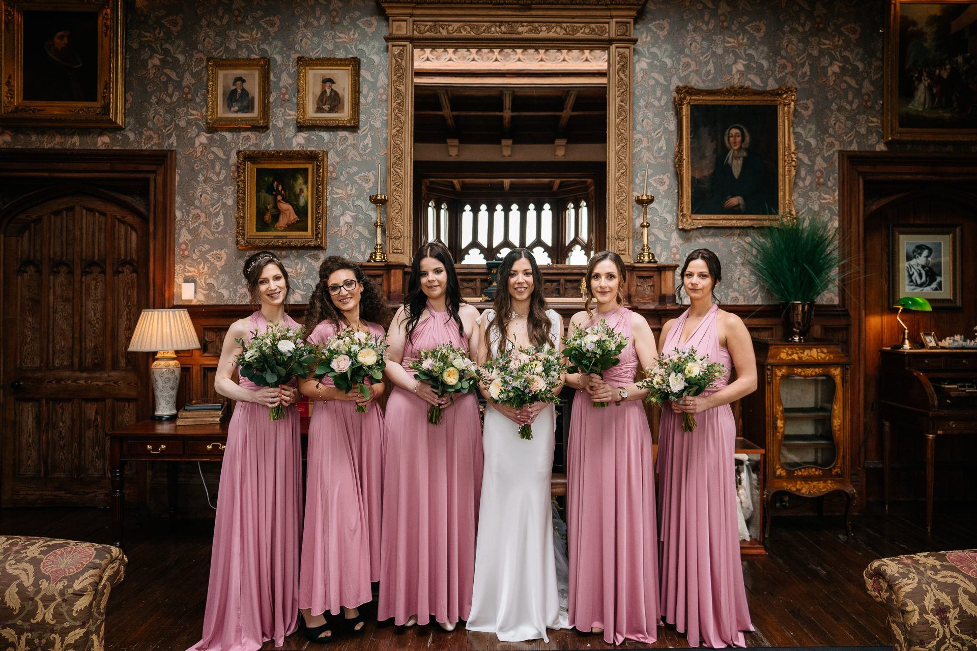 A group of women in dresses posing for a photo