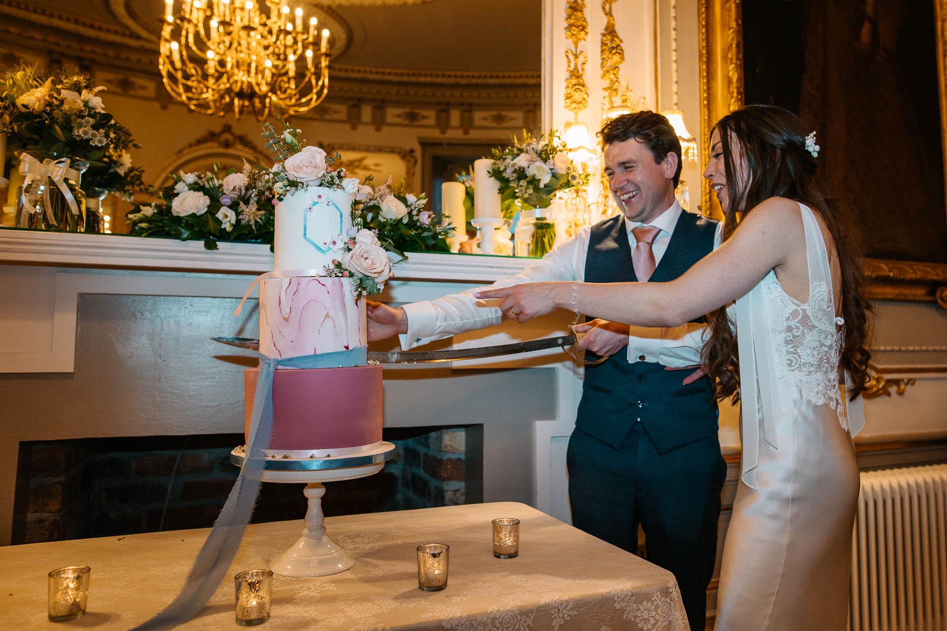 A bride and groom cutting a cake