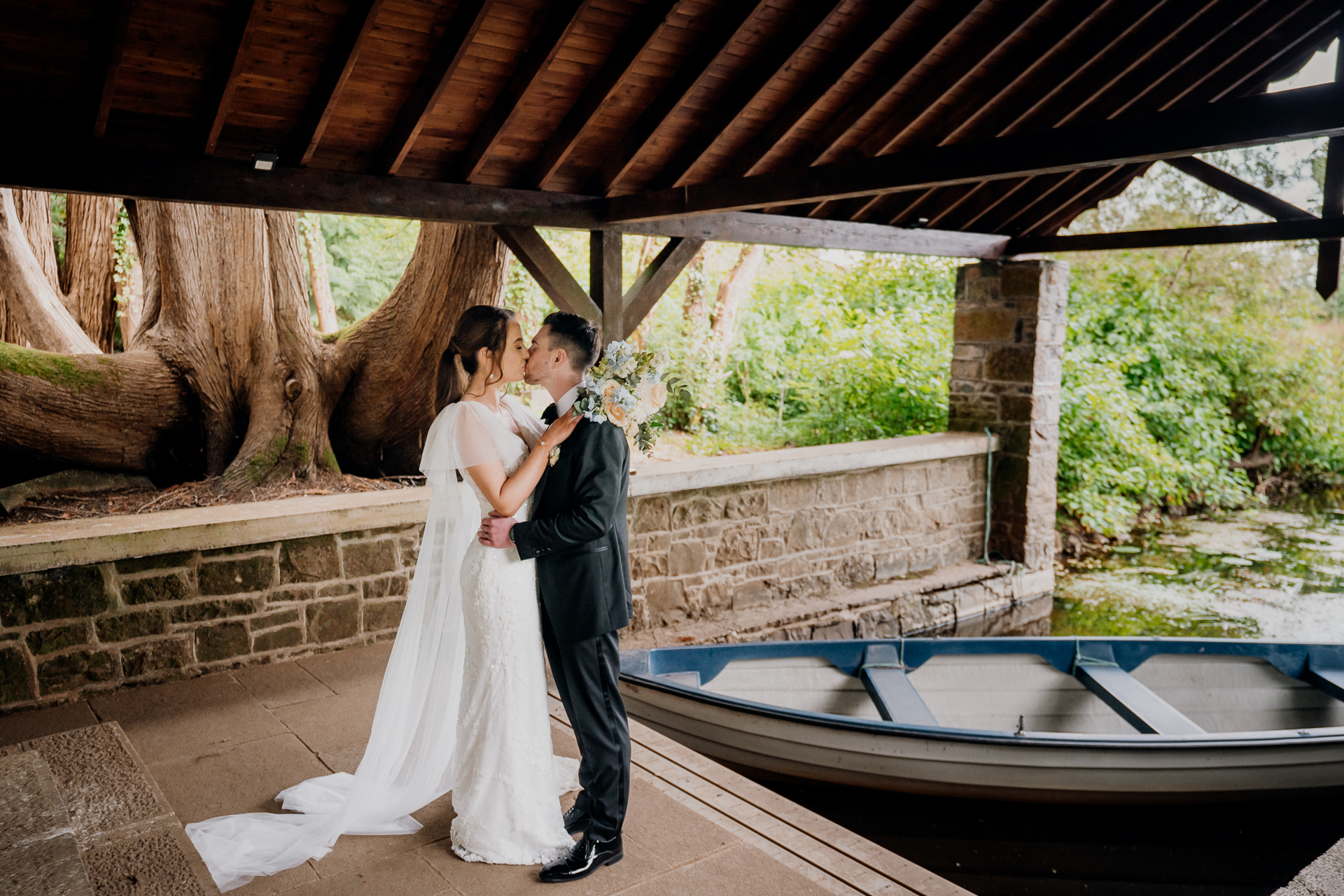 Romantic moment at Markree Castle Boathouse – bride and groom by the riverside