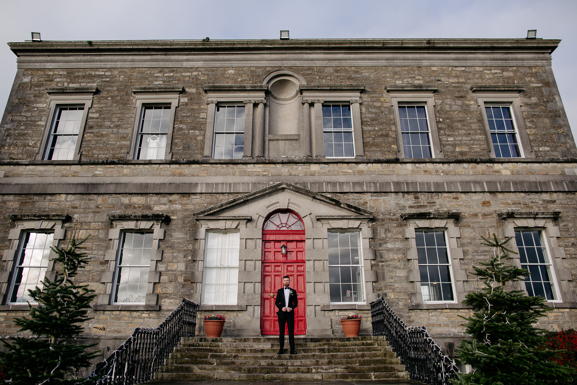 A person standing on the steps of a building