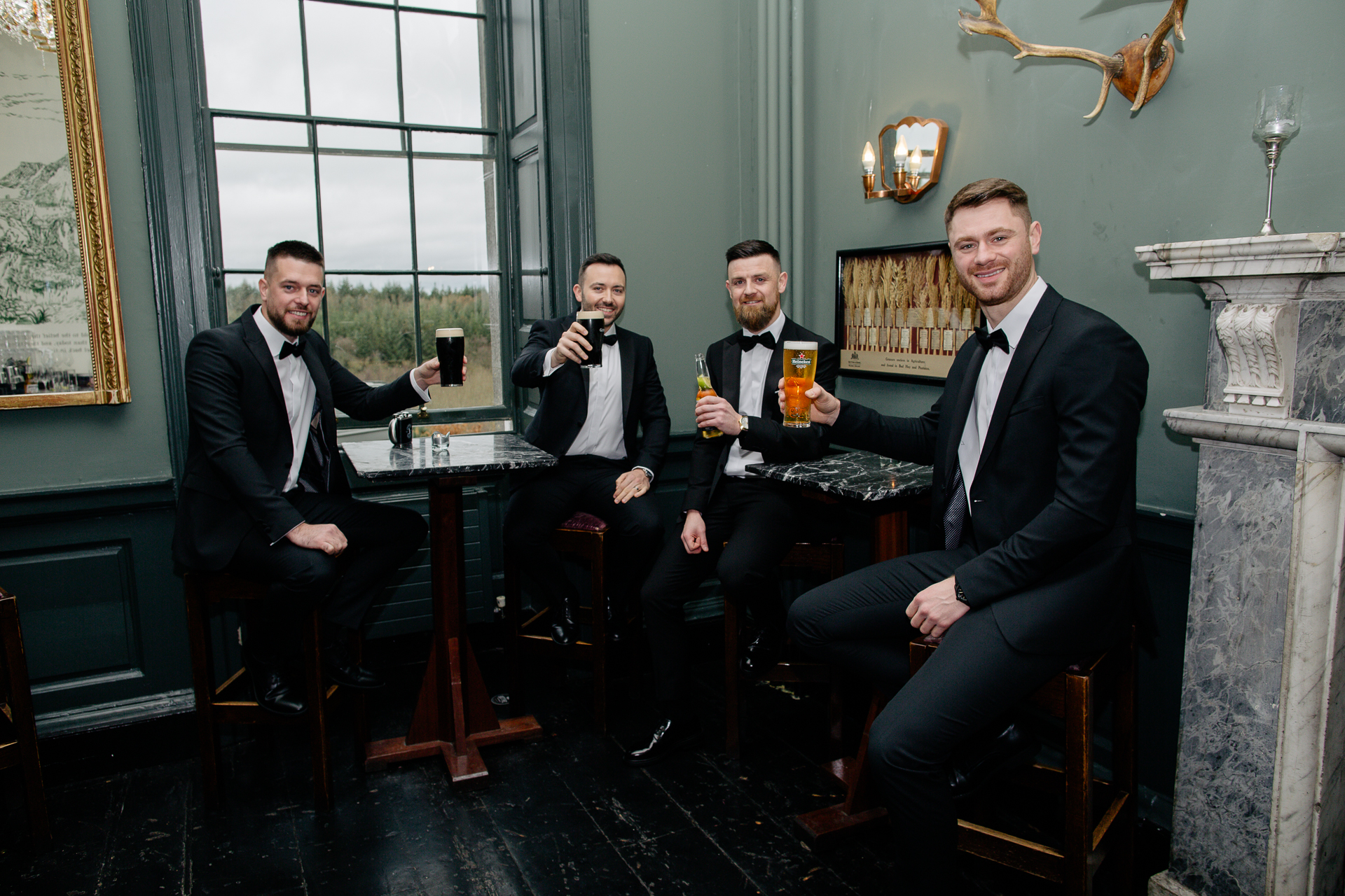 A group of men sitting at a table with drinks