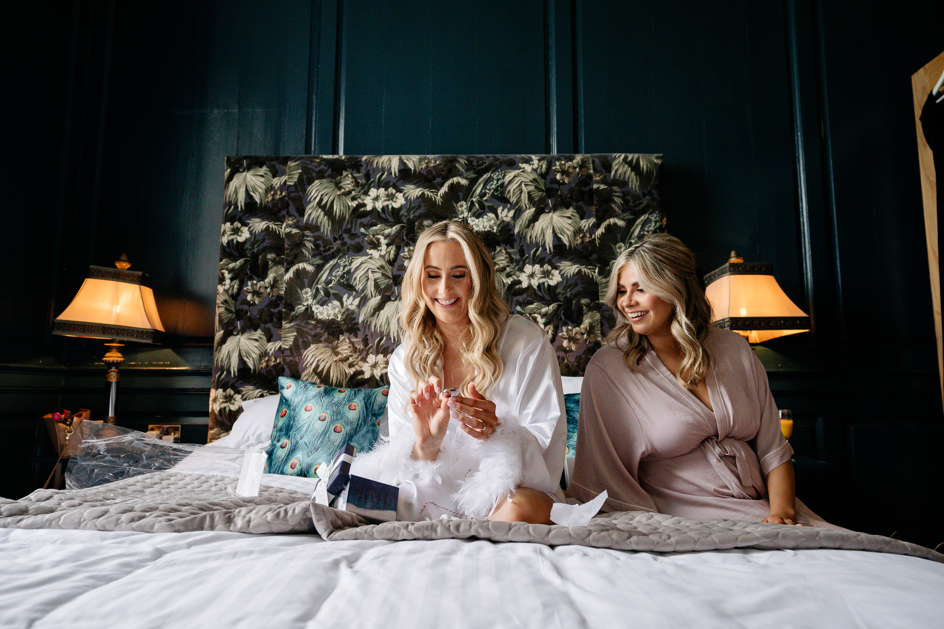 Two women sitting on a bed