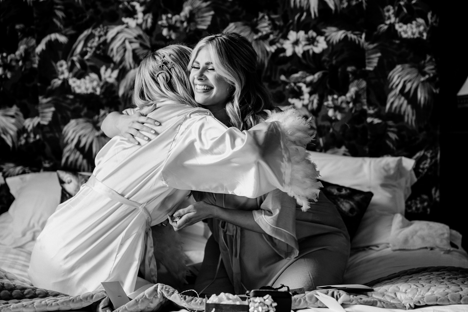 A couple of women sitting on a bed