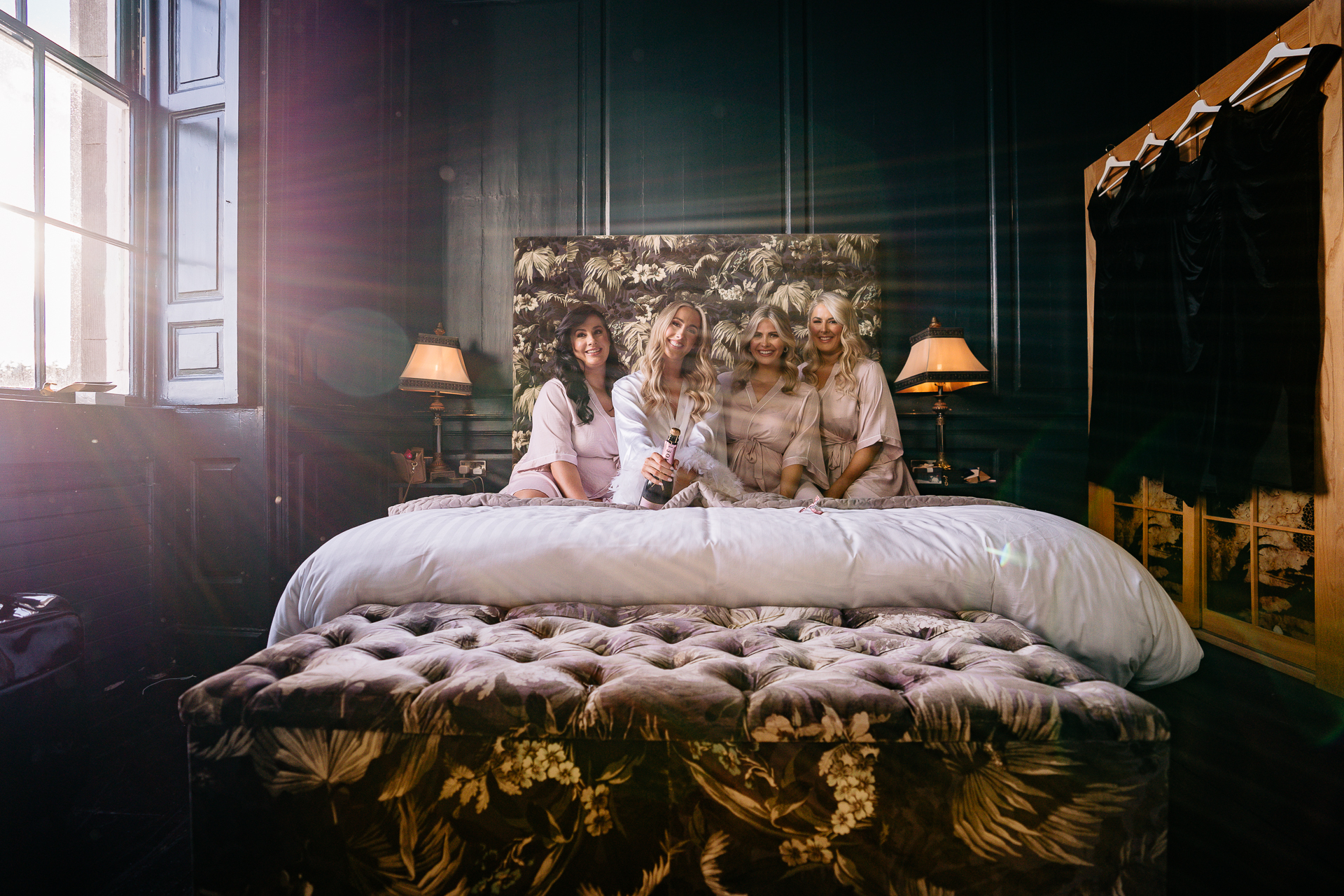 A group of women sitting on a bed