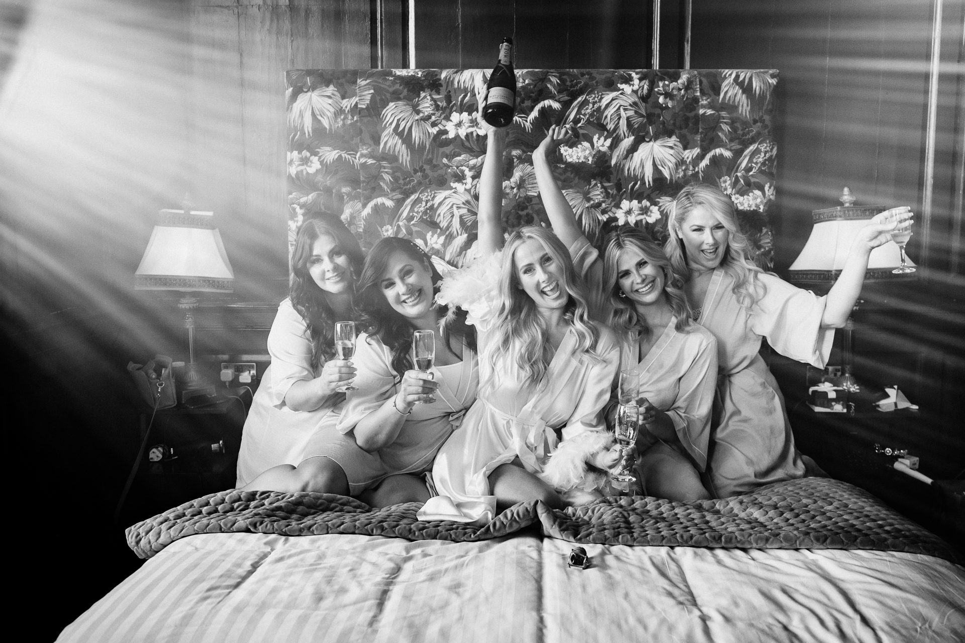 A group of women sitting on a bed