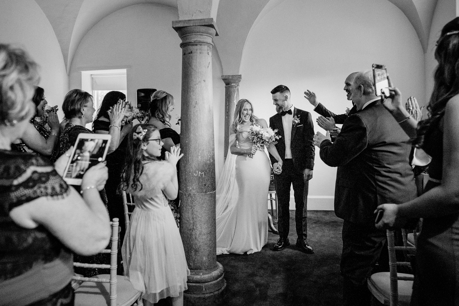 A bride and groom walking down the aisle