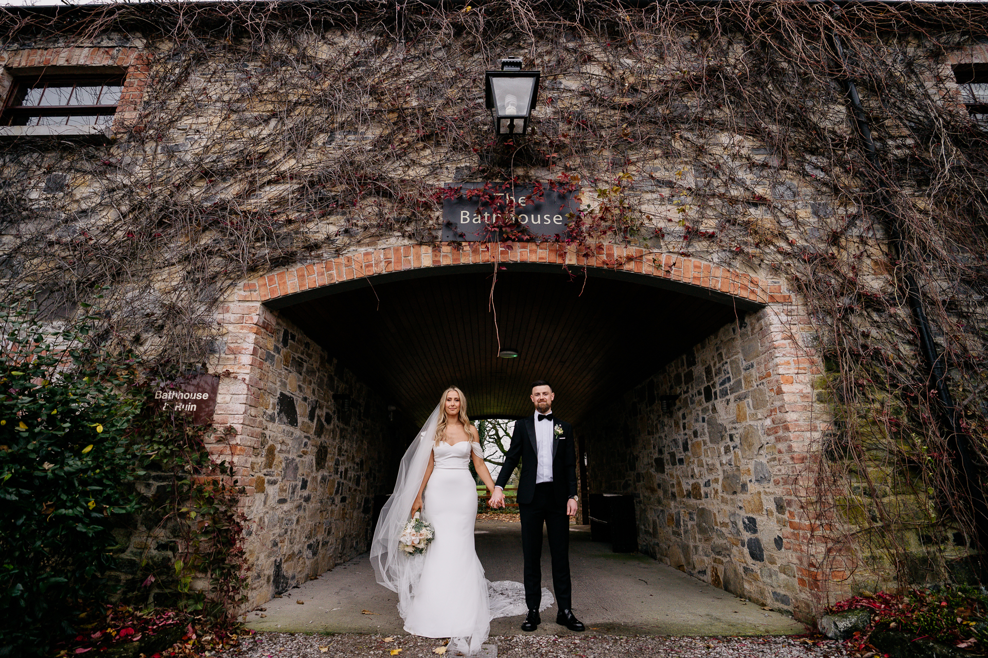 A man and woman posing for a picture in a stone tunnel