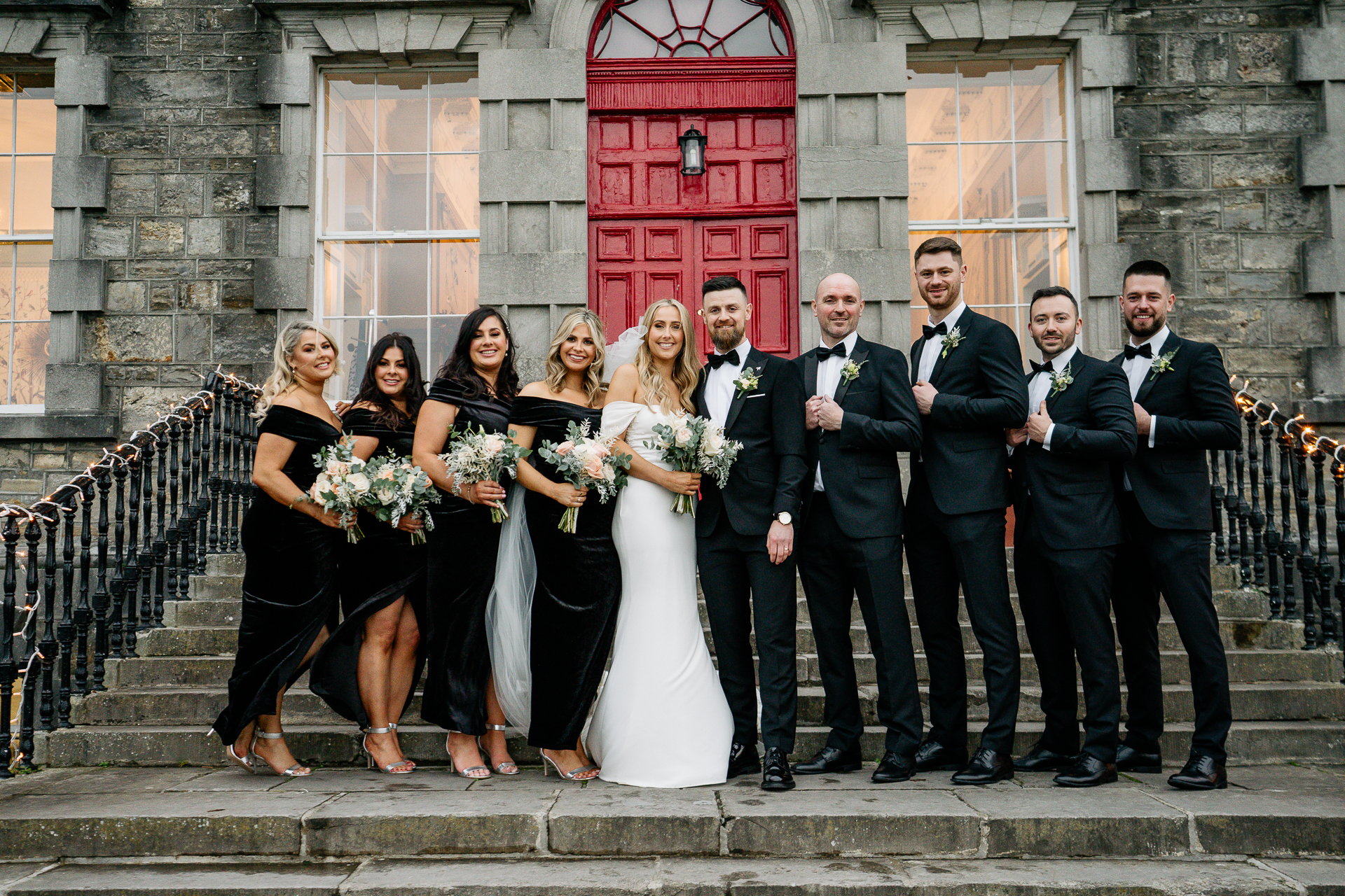 A group of people posing for a photo on stairs