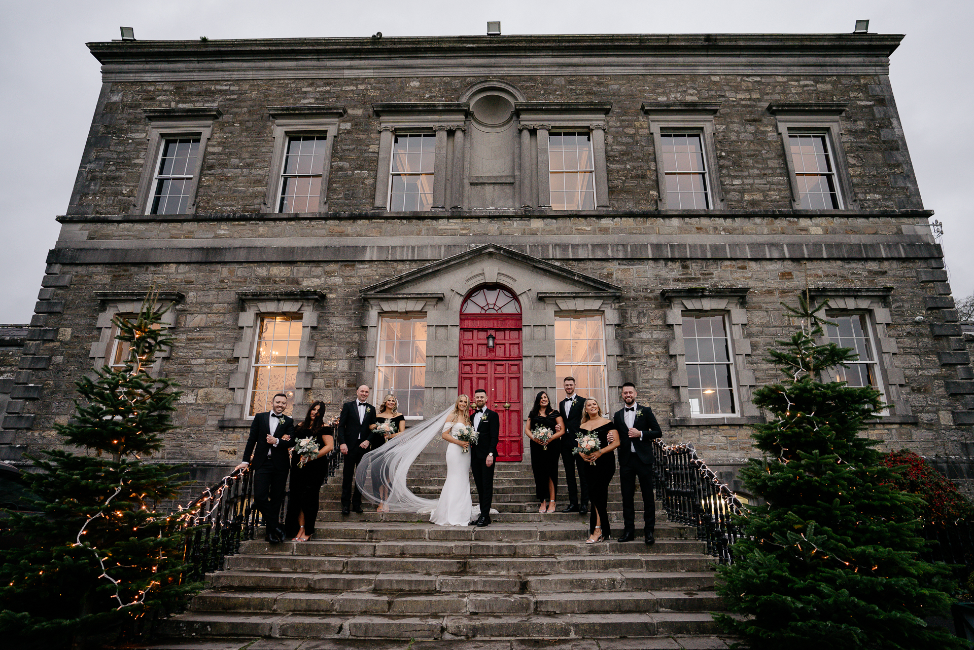 A group of people posing for a photo in front of a building