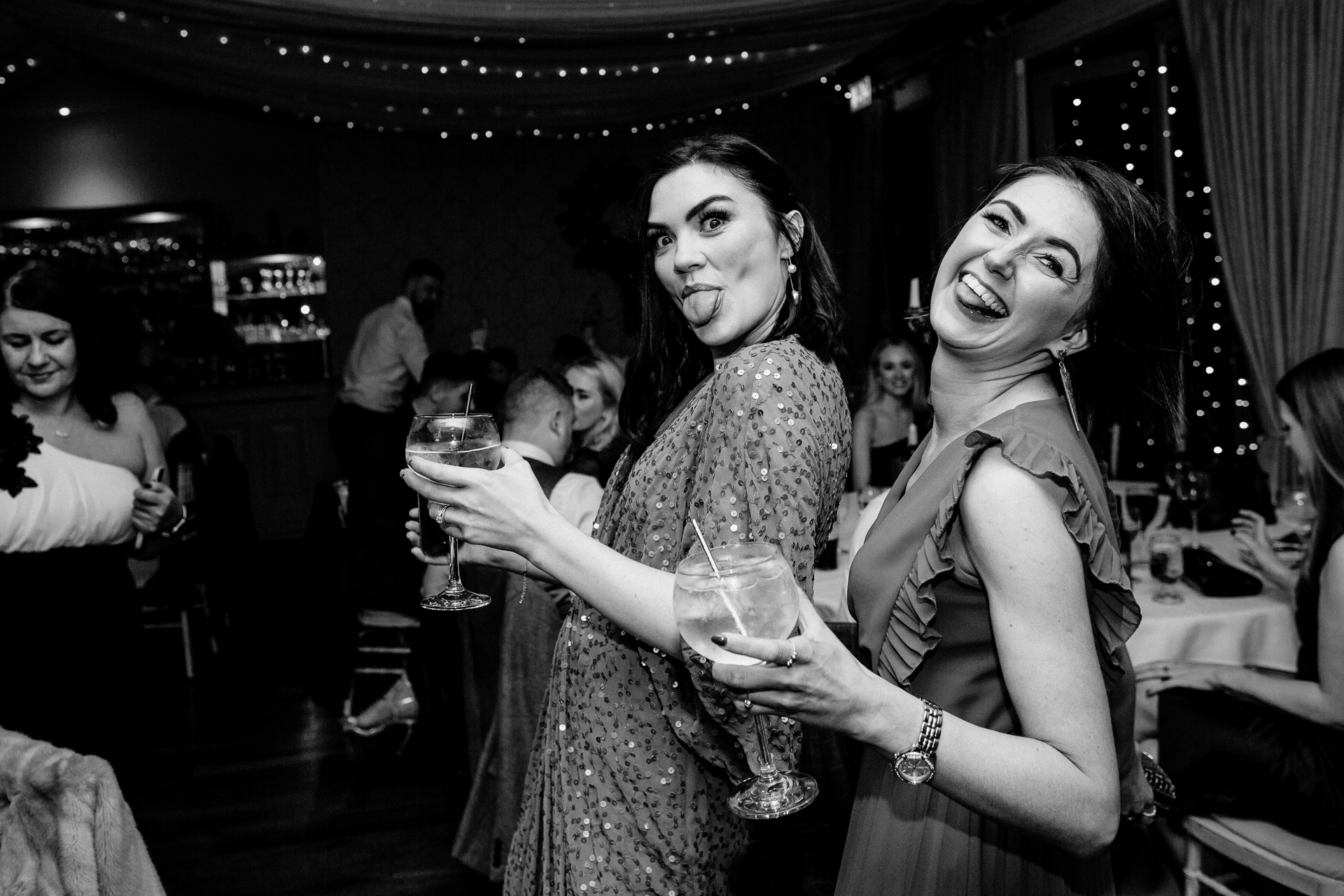 A couple of women holding glasses of wine