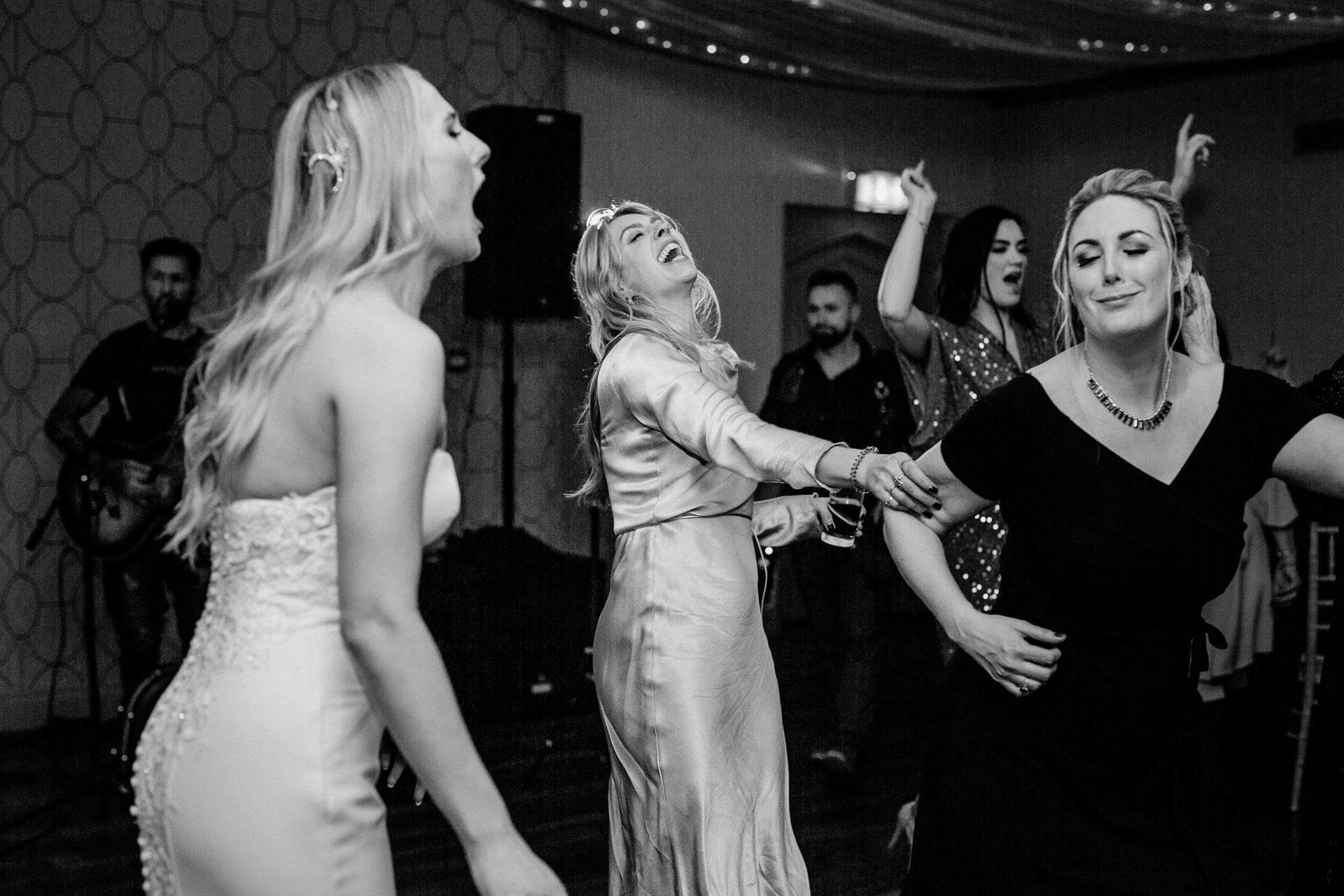 A group of women dancing with Studio 54 in the background