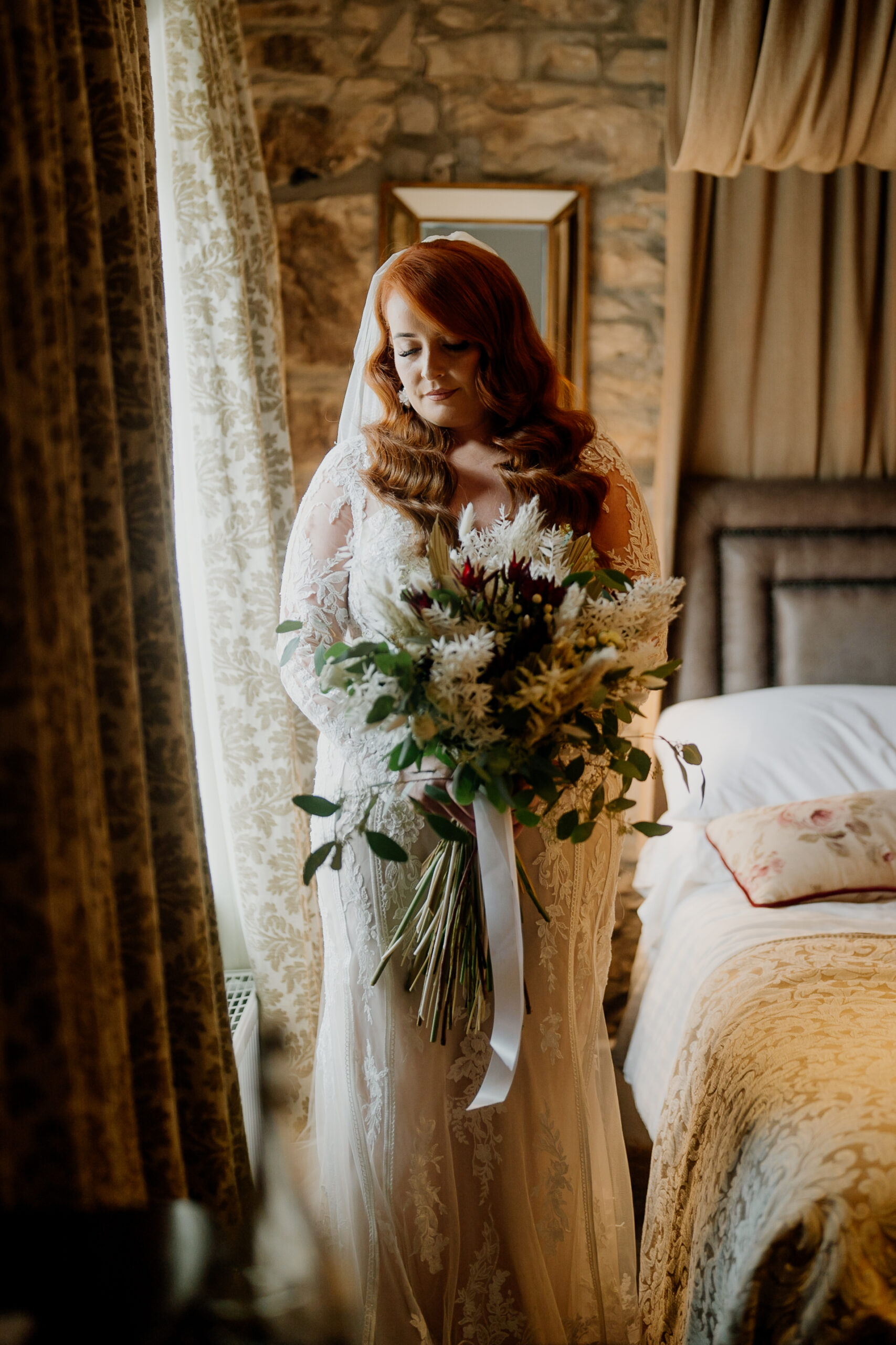 A person in a dress holding flowers