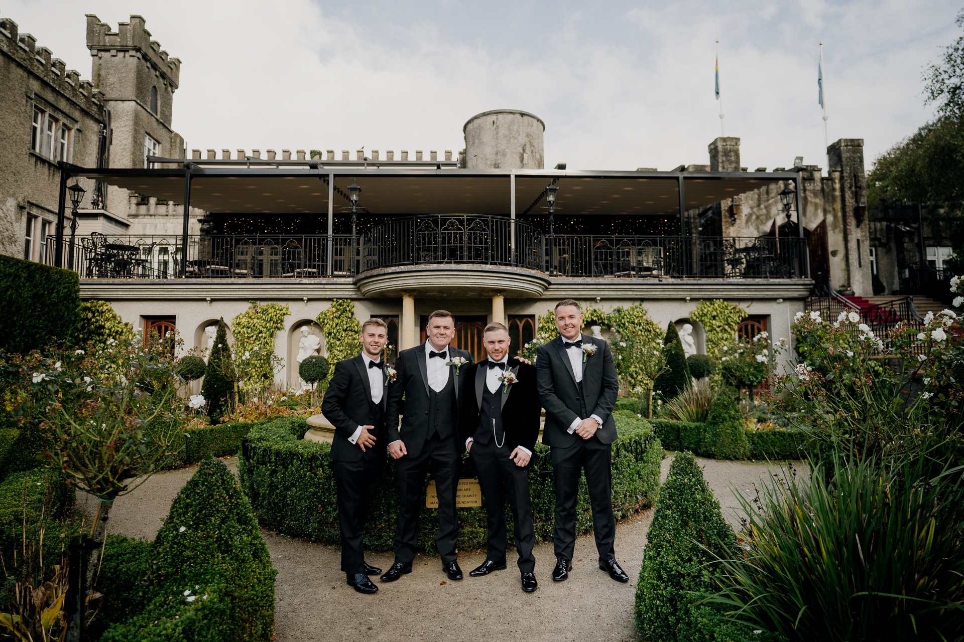 A group of men in suits standing in front of a building