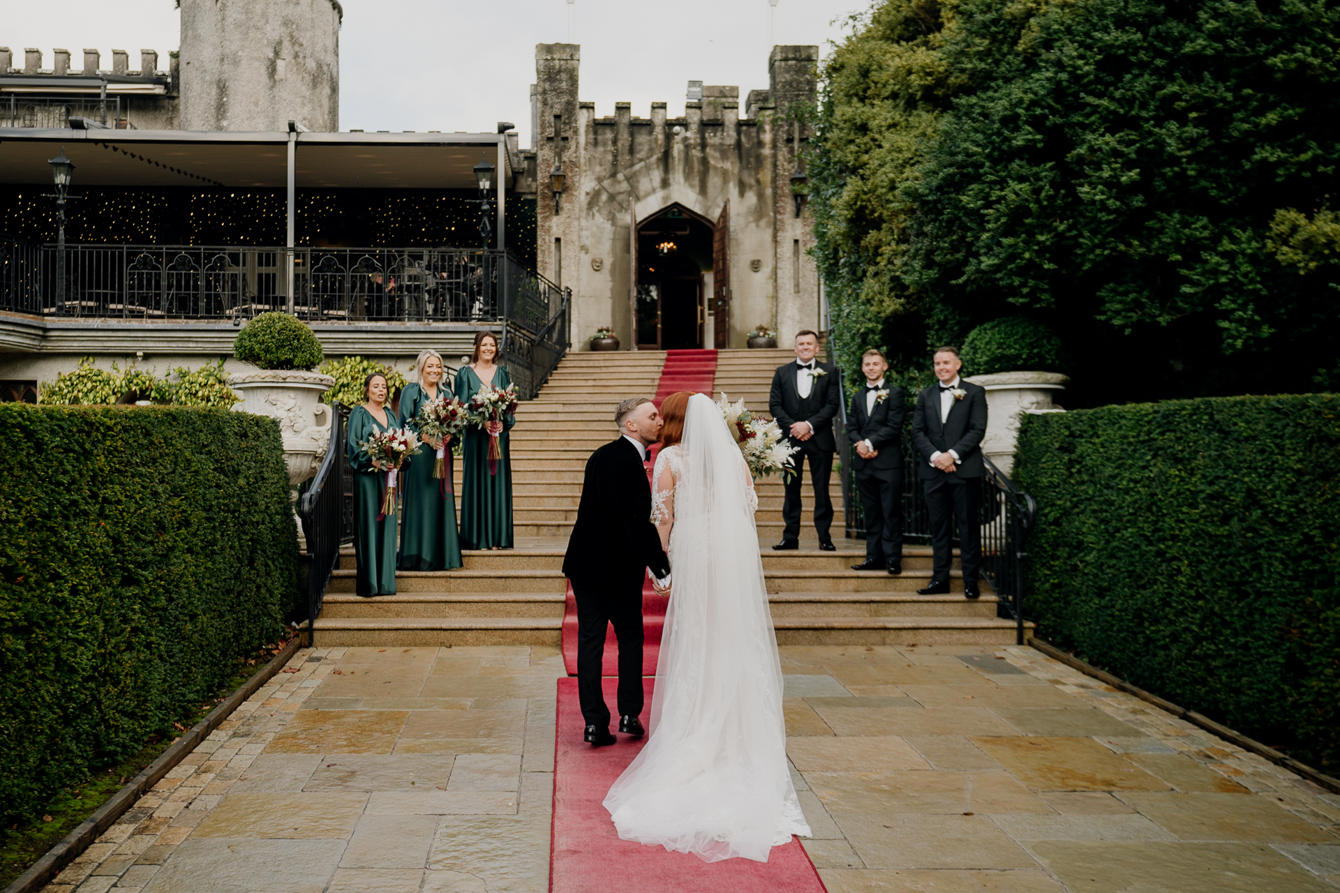 A bride and groom walking down the stairs