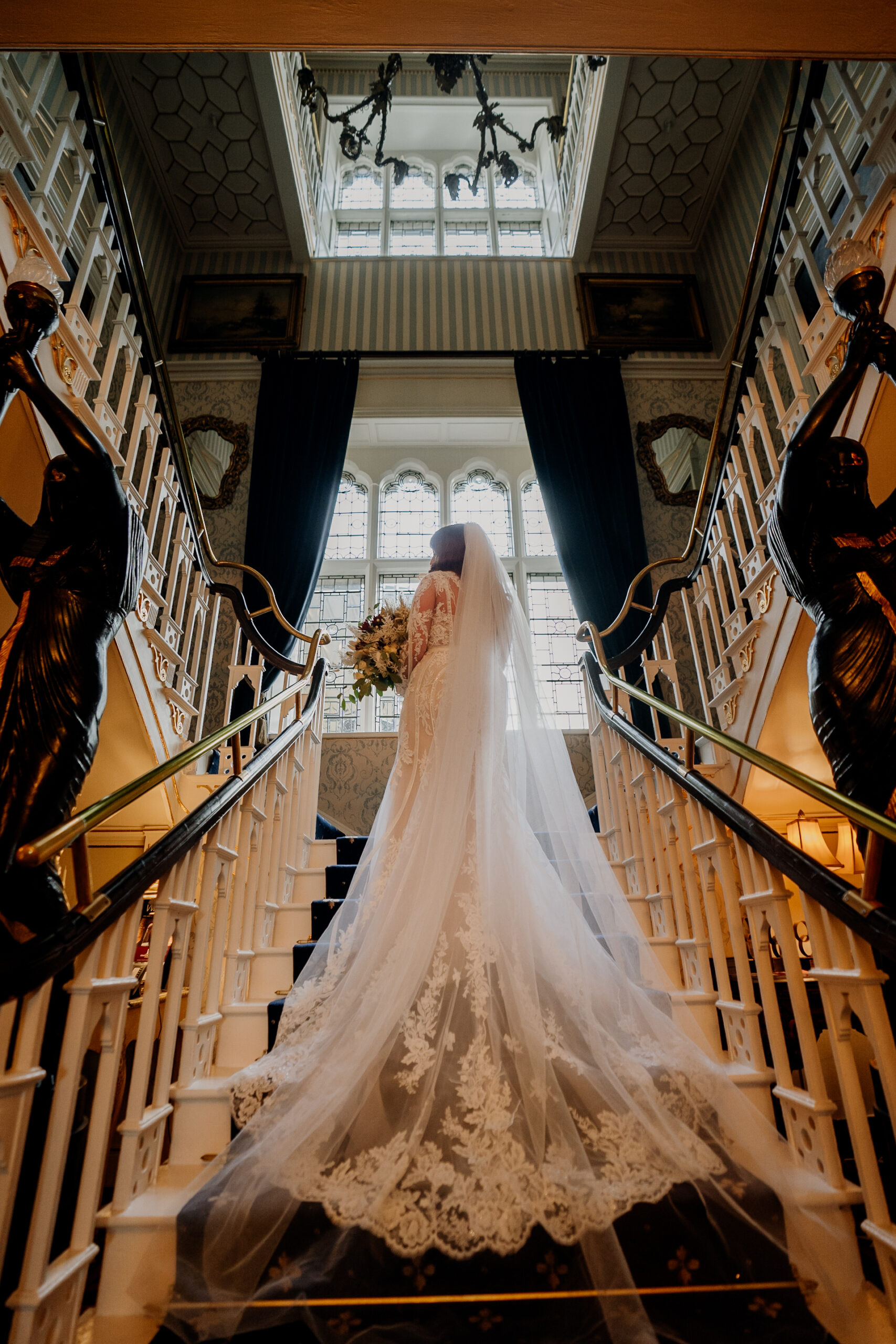 A bride and groom walking down a flight of stairs