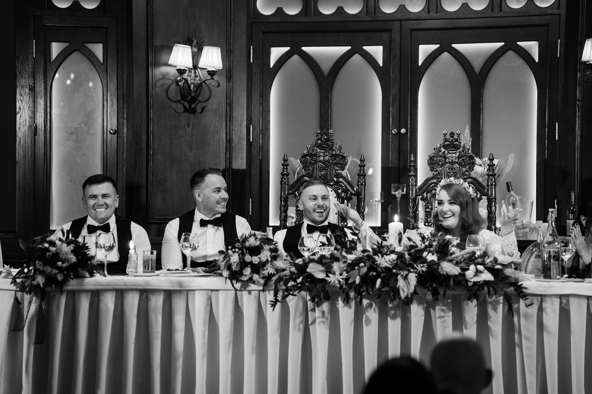 A group of people sitting at a table with flowers