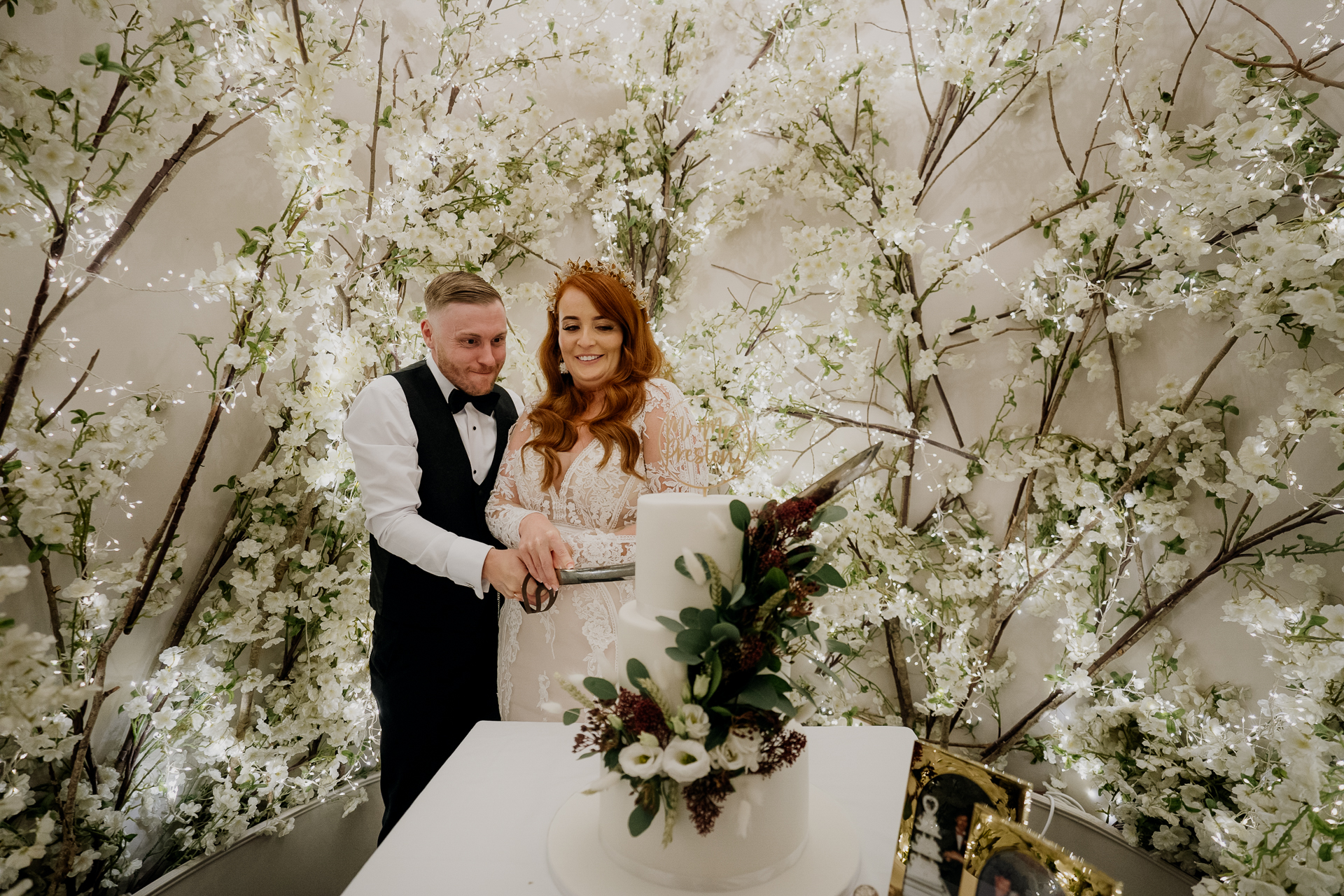 A bride and groom cutting a cake