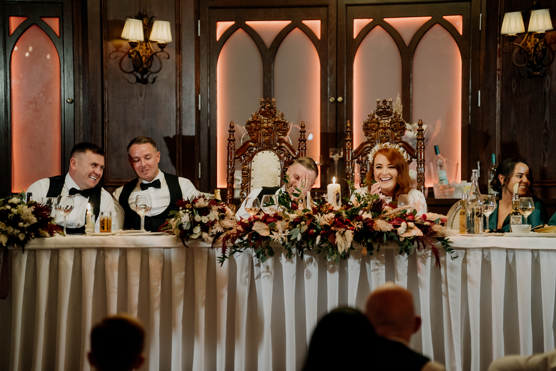 A group of people sitting at a table with flowers