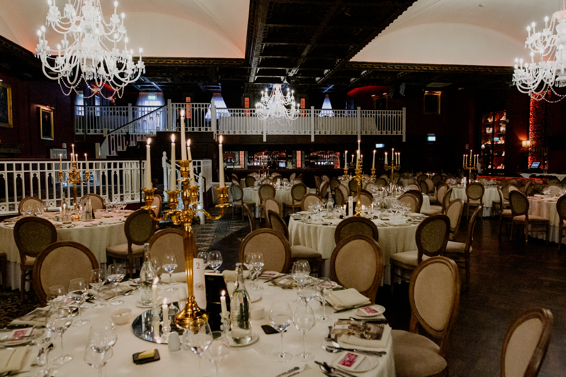 A large room with tables set for a meal