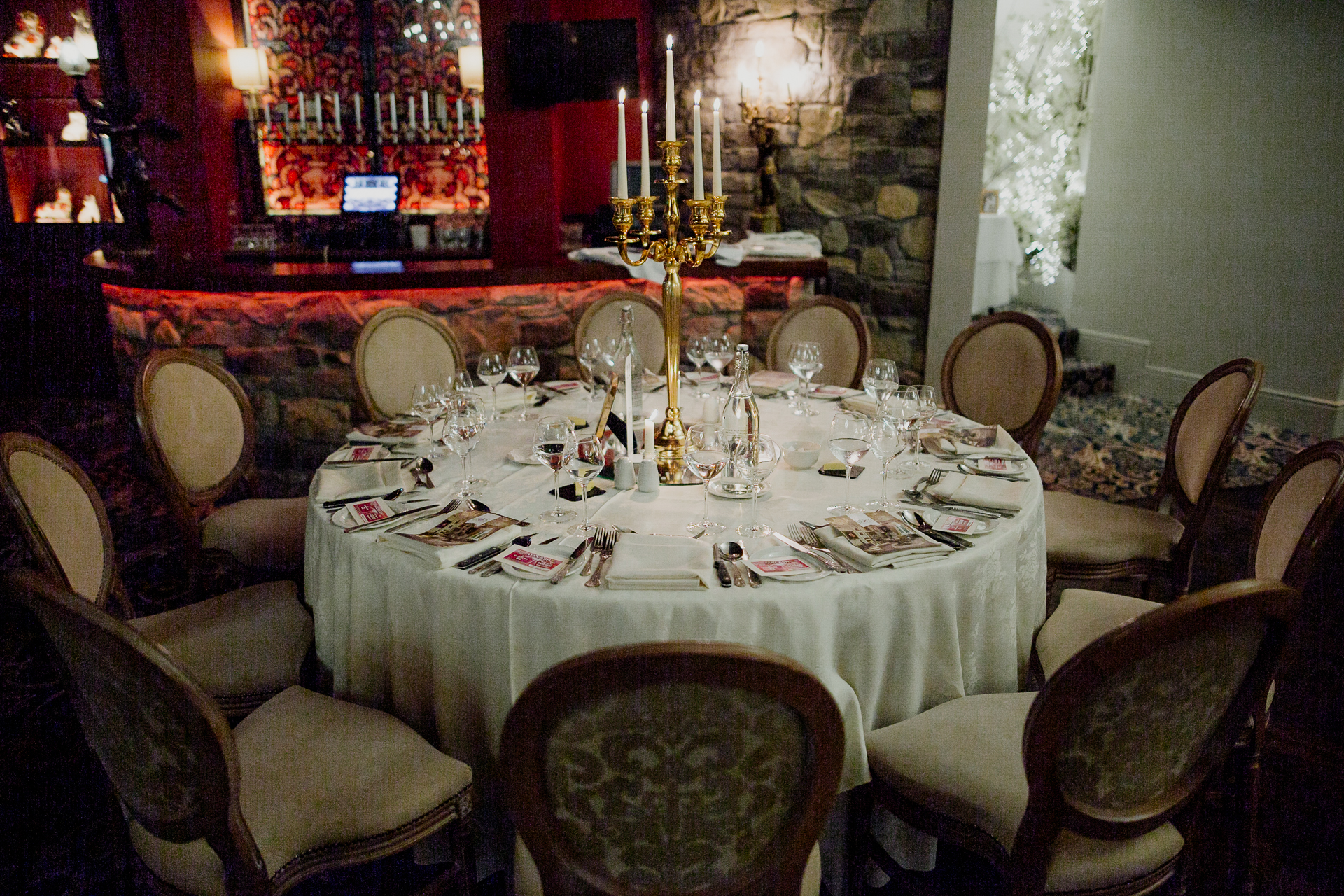 A dining table with a set of chairs and a chandelier