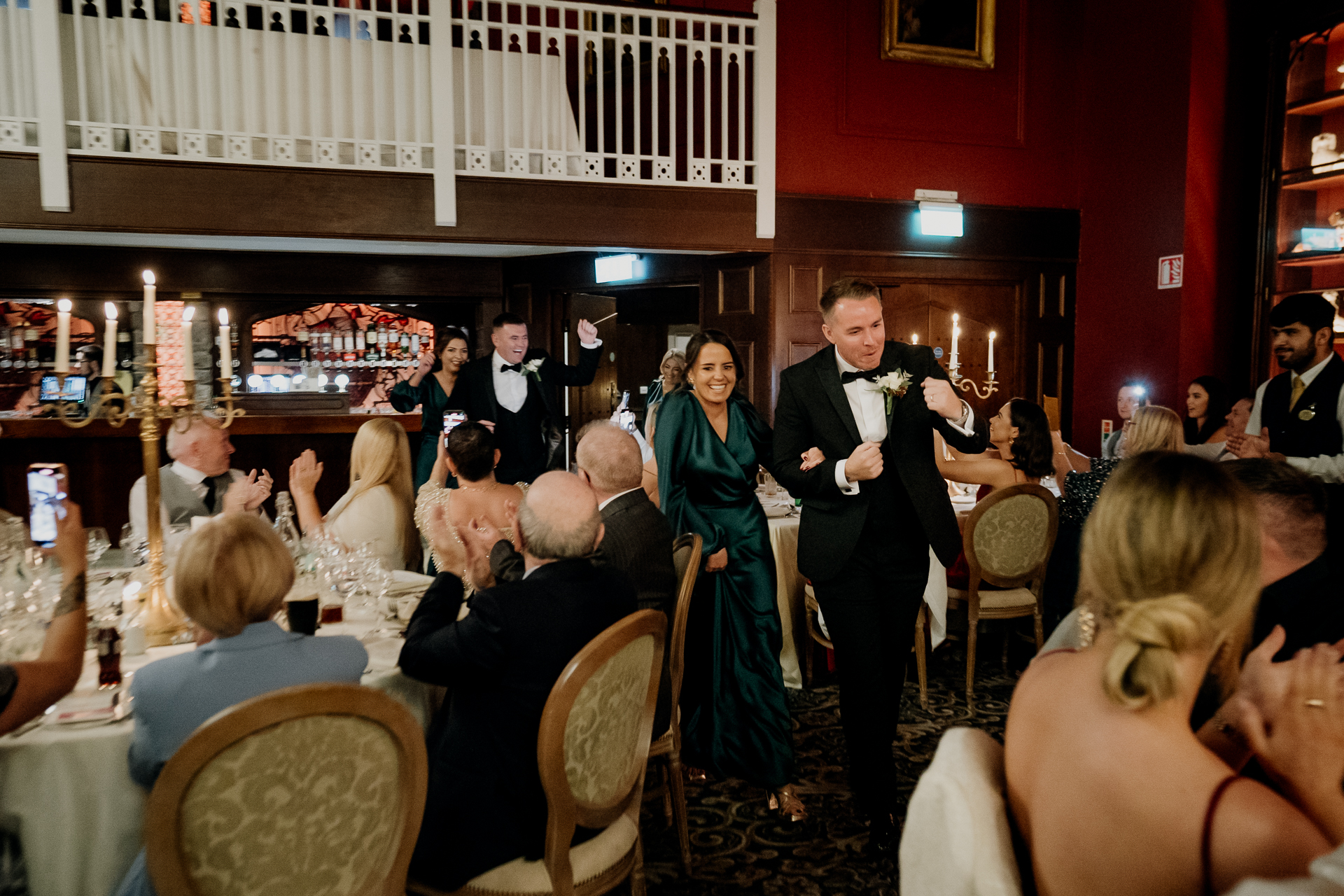 A man and woman dancing in a room full of people