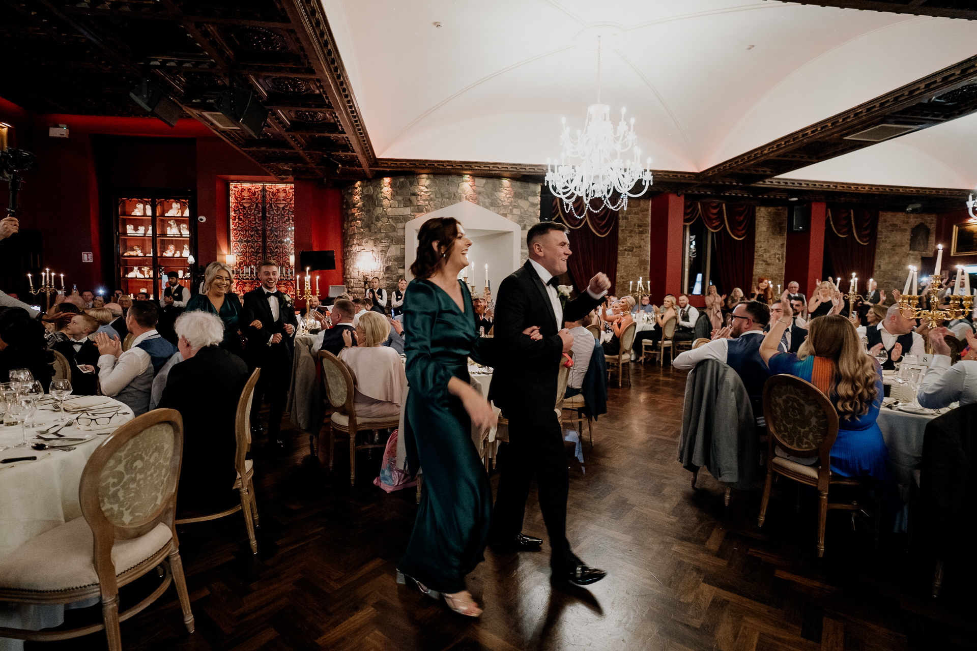 A man and woman dancing in a room full of people