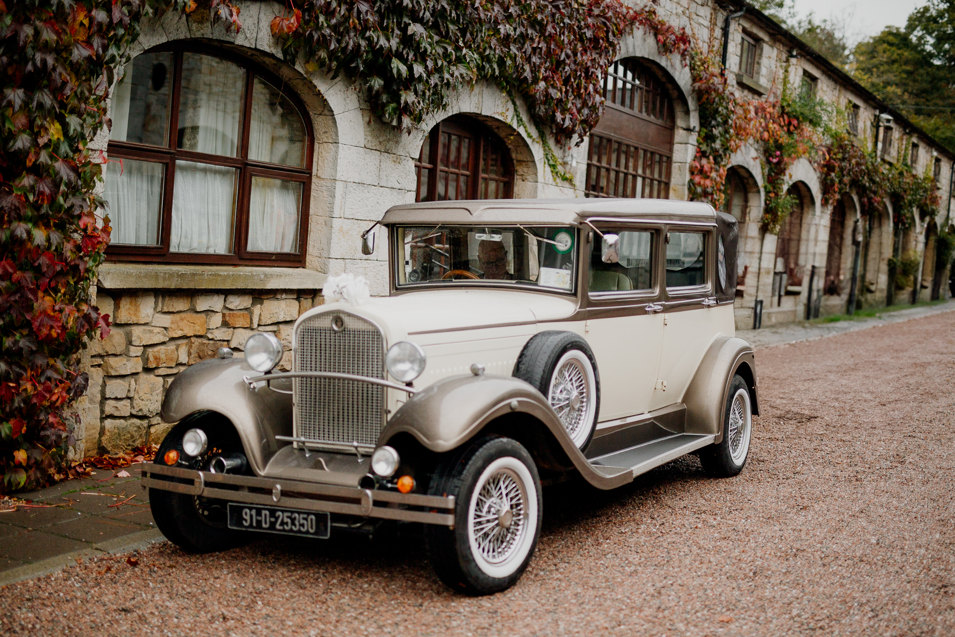 An old car parked on the side of a road