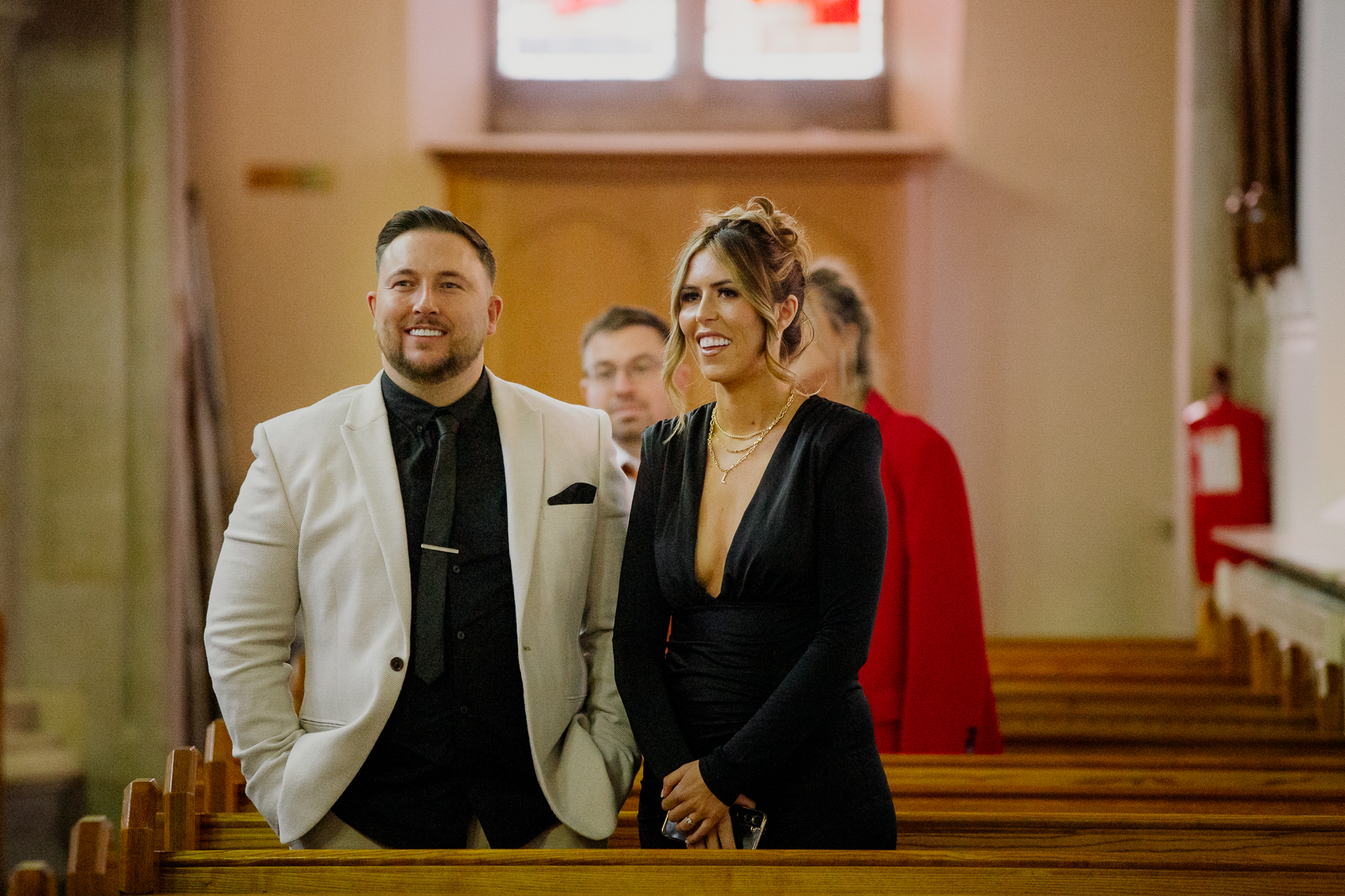 A man and woman standing next to each other and smiling