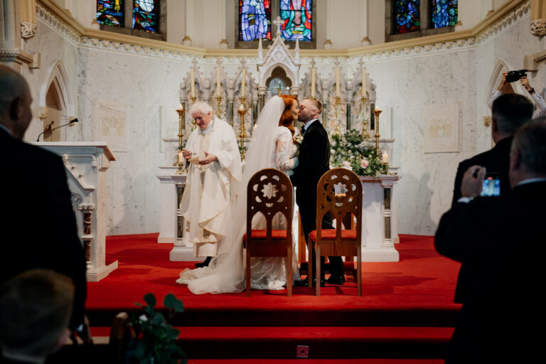 A person in a white robe standing next to a person in a robe