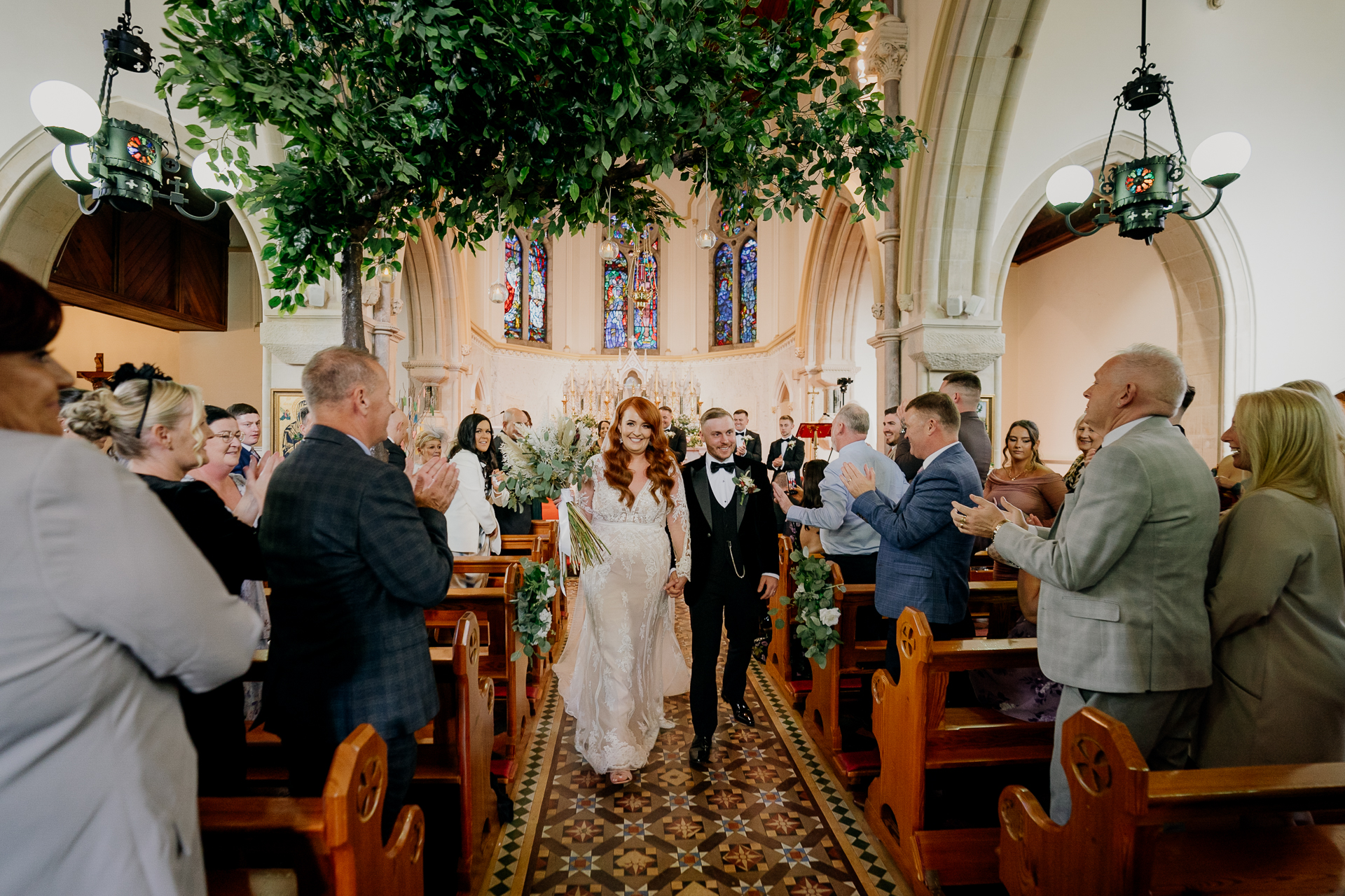 A bride and groom walking down the aisle