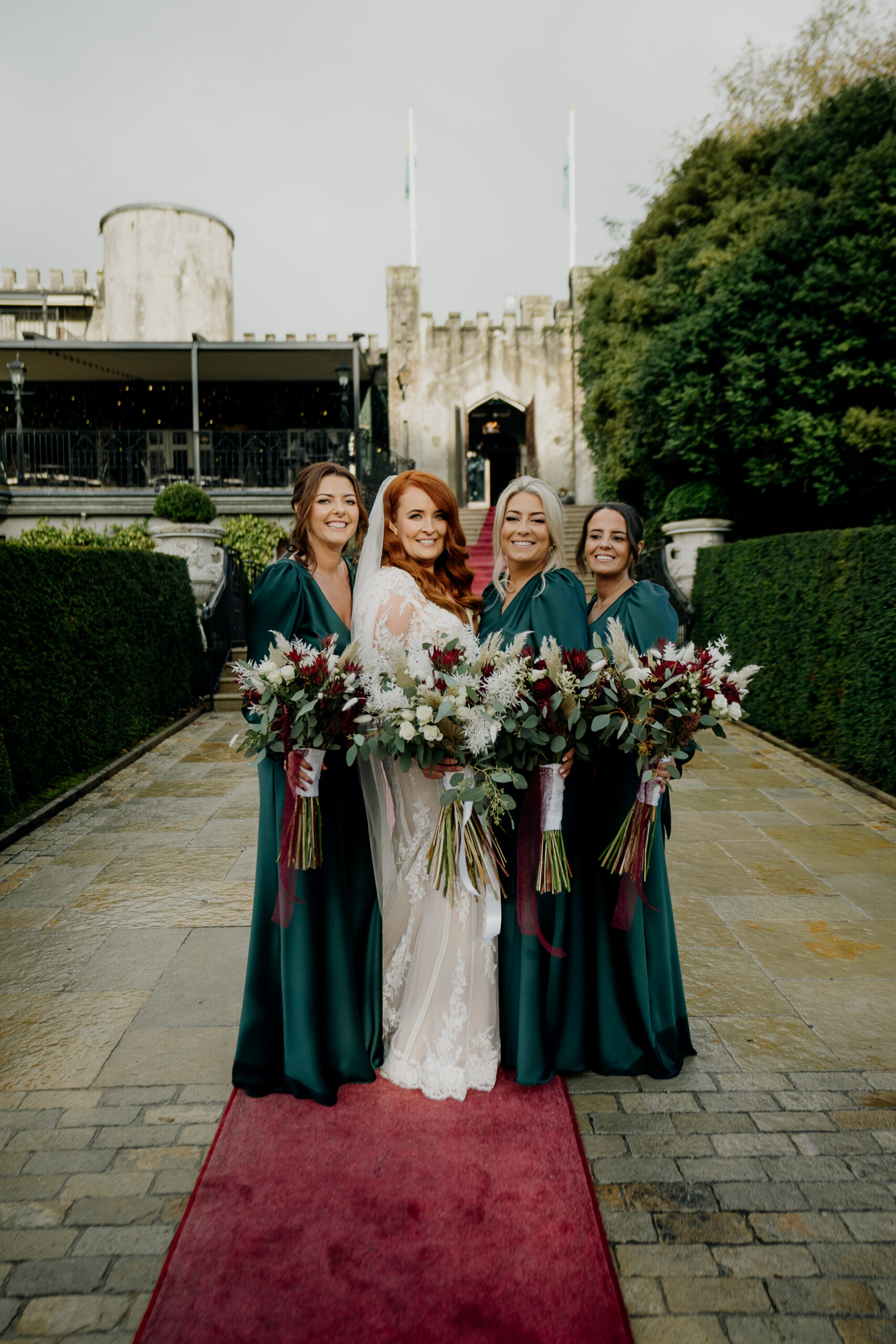 A group of women in dresses and dresses posing for a photo