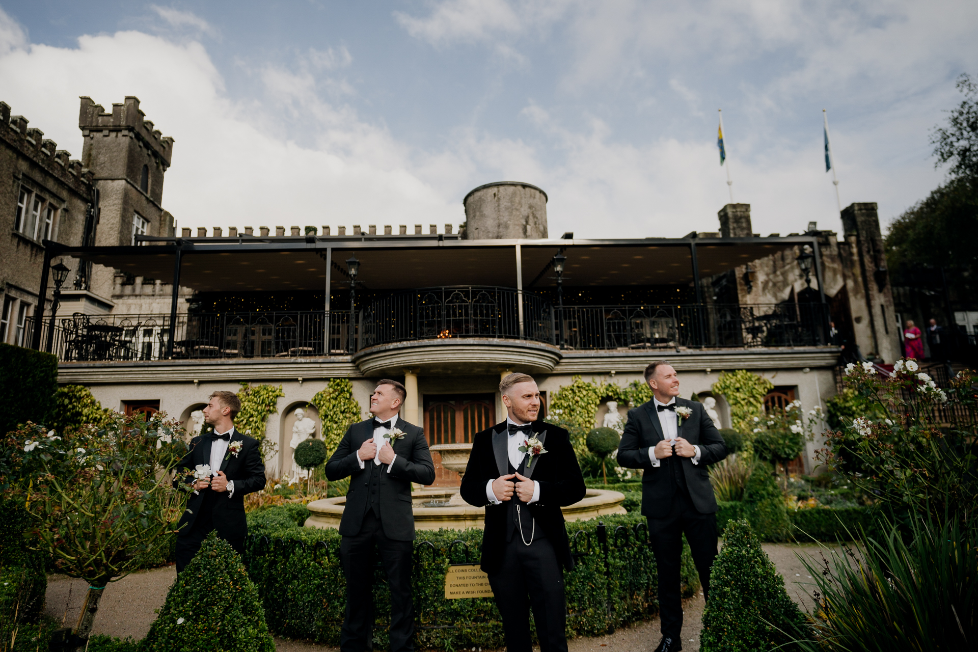 A group of men in suits standing in front of a building