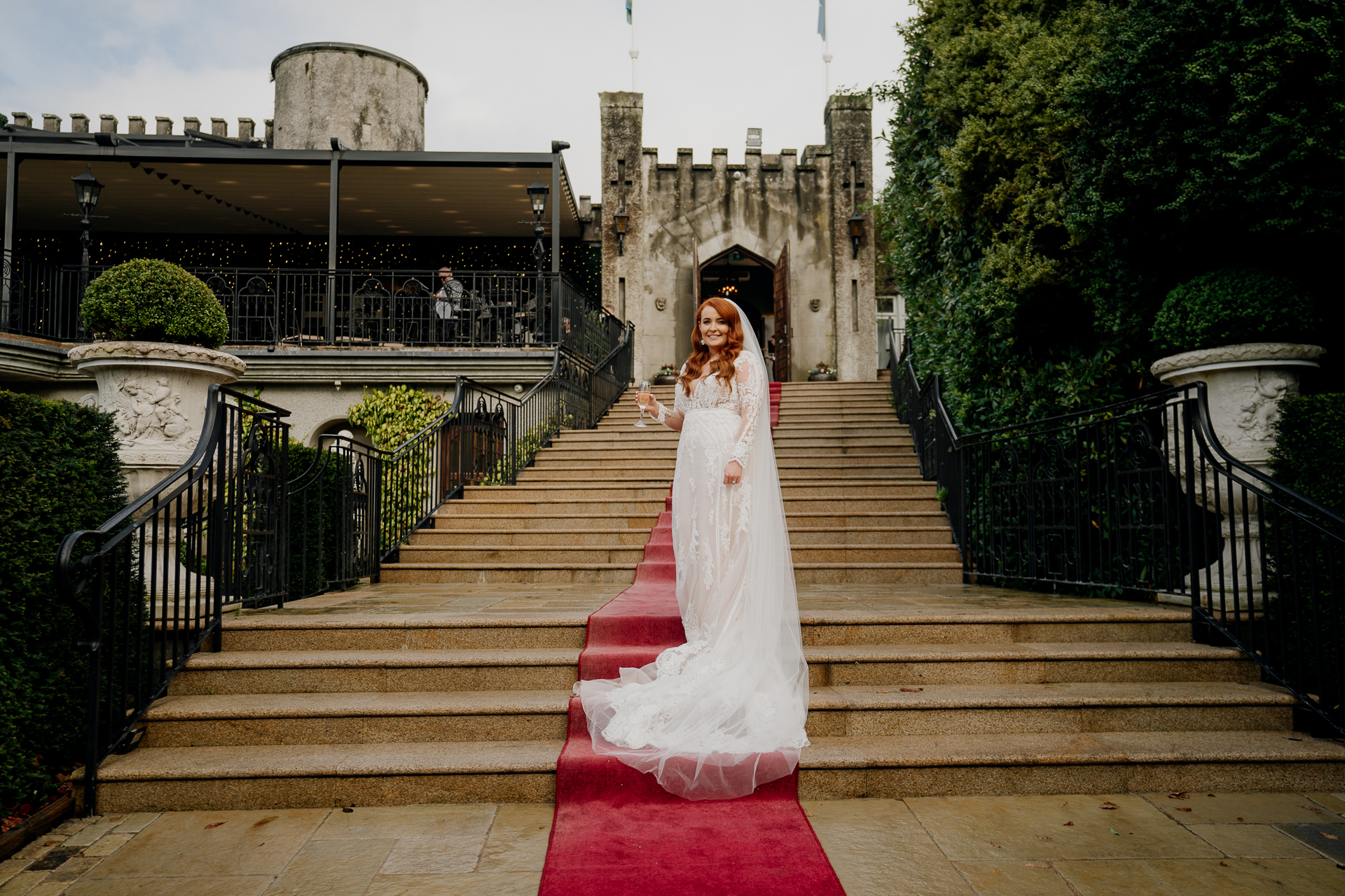 A person in a wedding dress on stairs outside a building