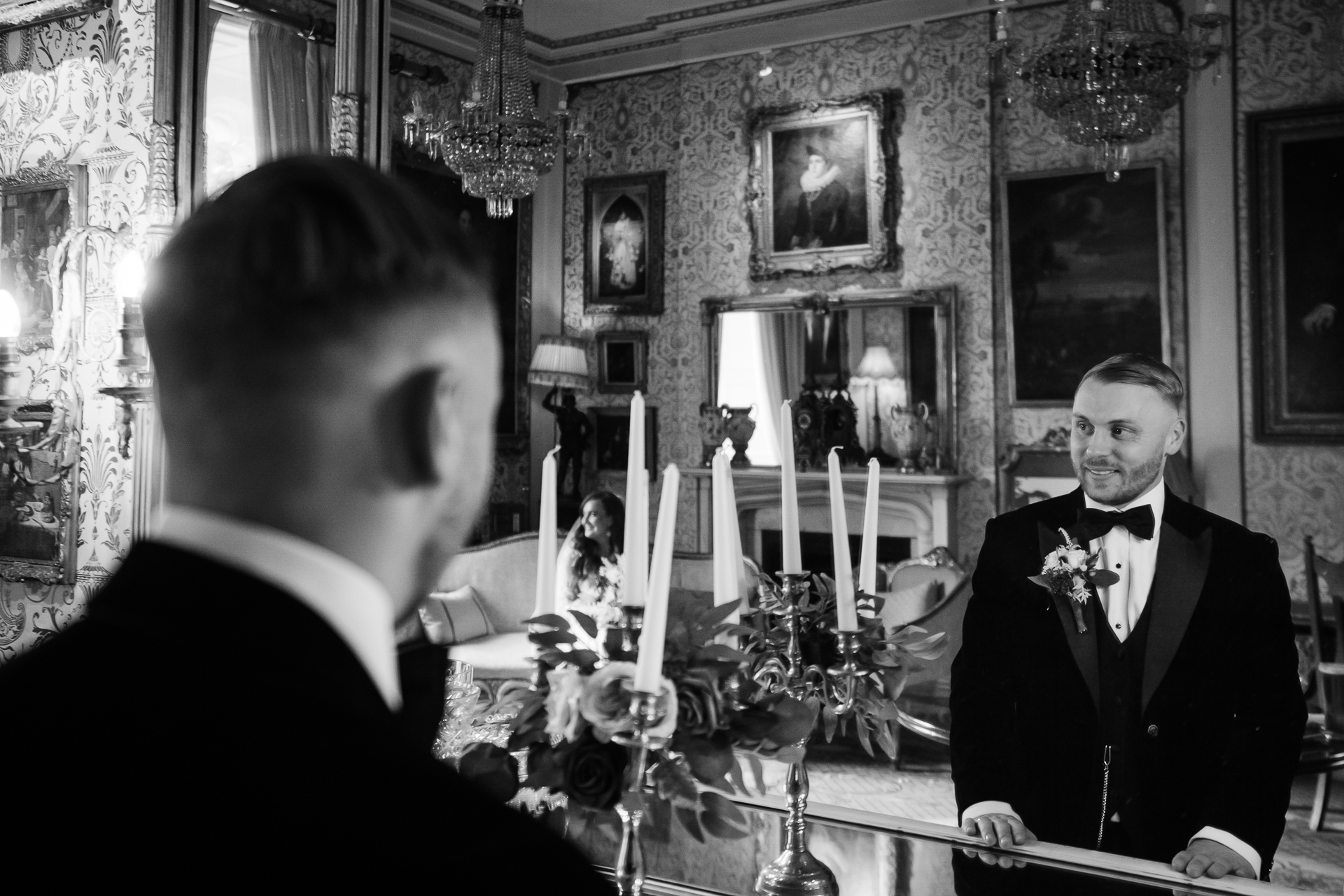 A man in a suit and a man in a suit sitting at a table