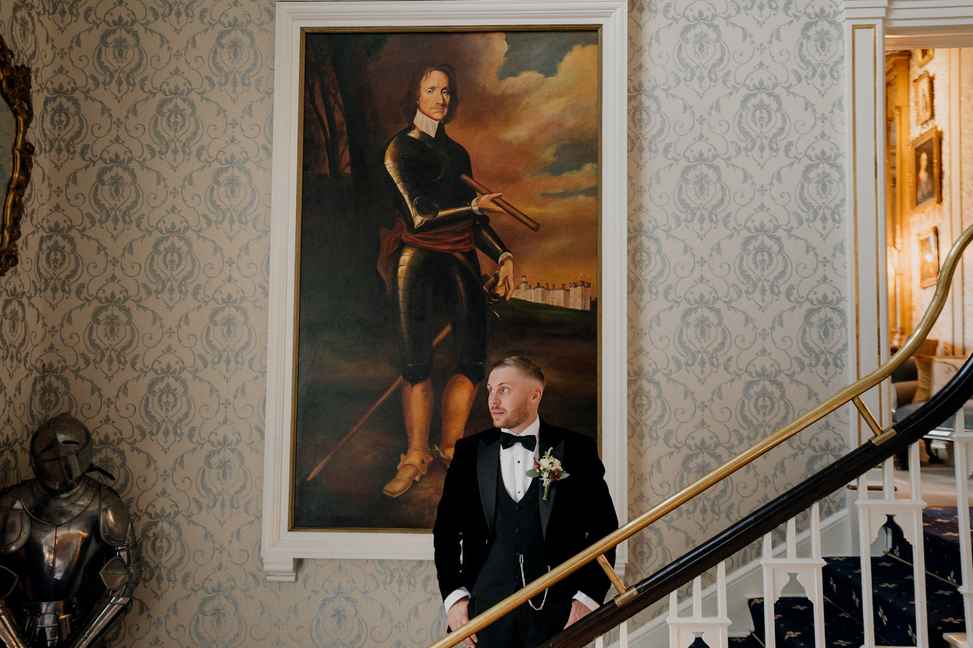 A man in a suit and tie standing on a staircase