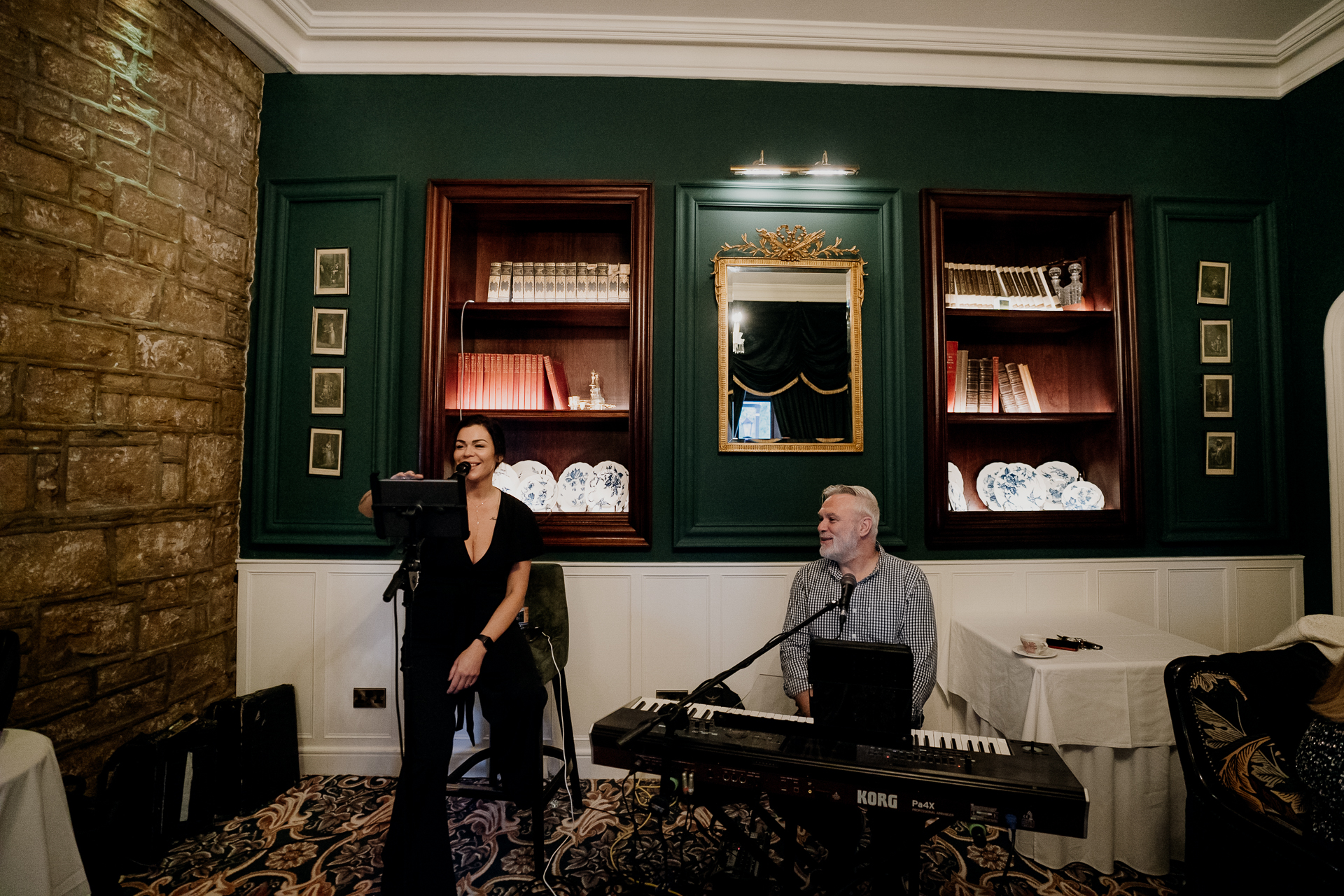 A man and a woman in a room with a laptop