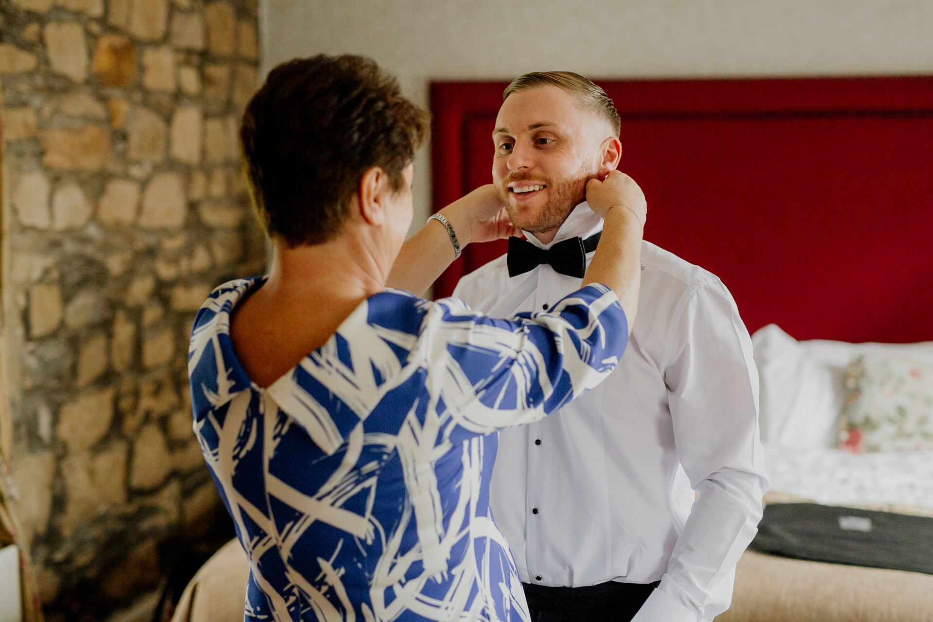 A man putting on a shirt