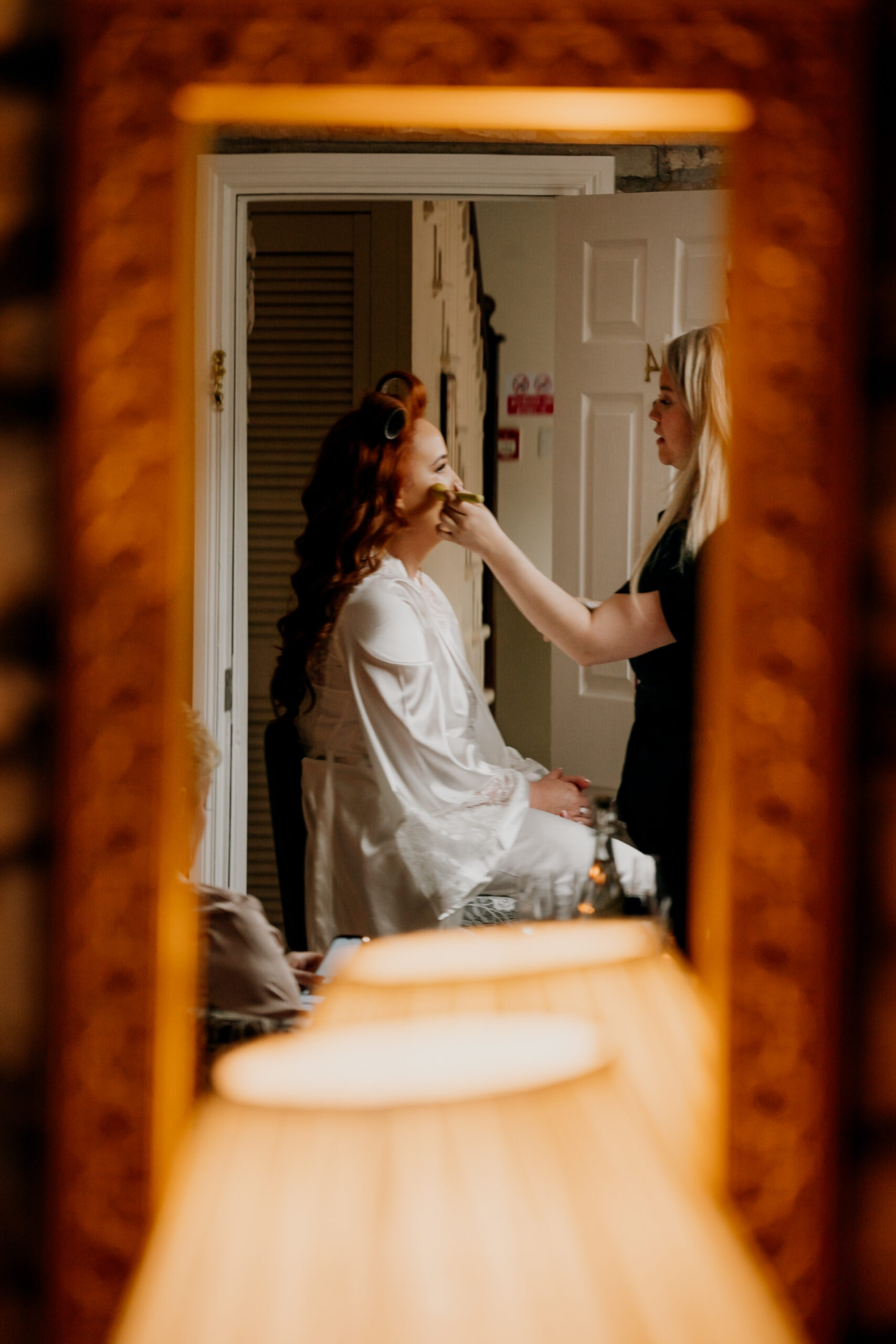 A woman taking a picture of another woman in a bathroom