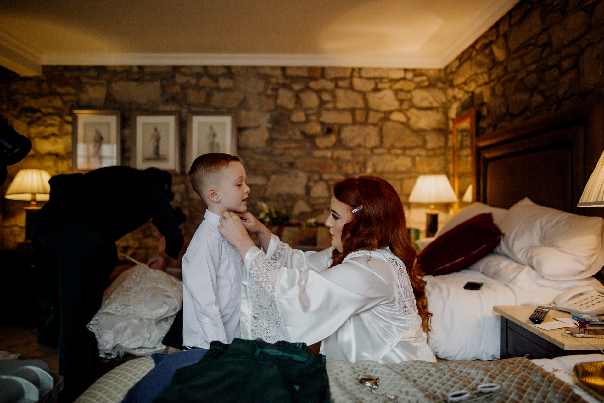 A woman and a man sitting on a bed