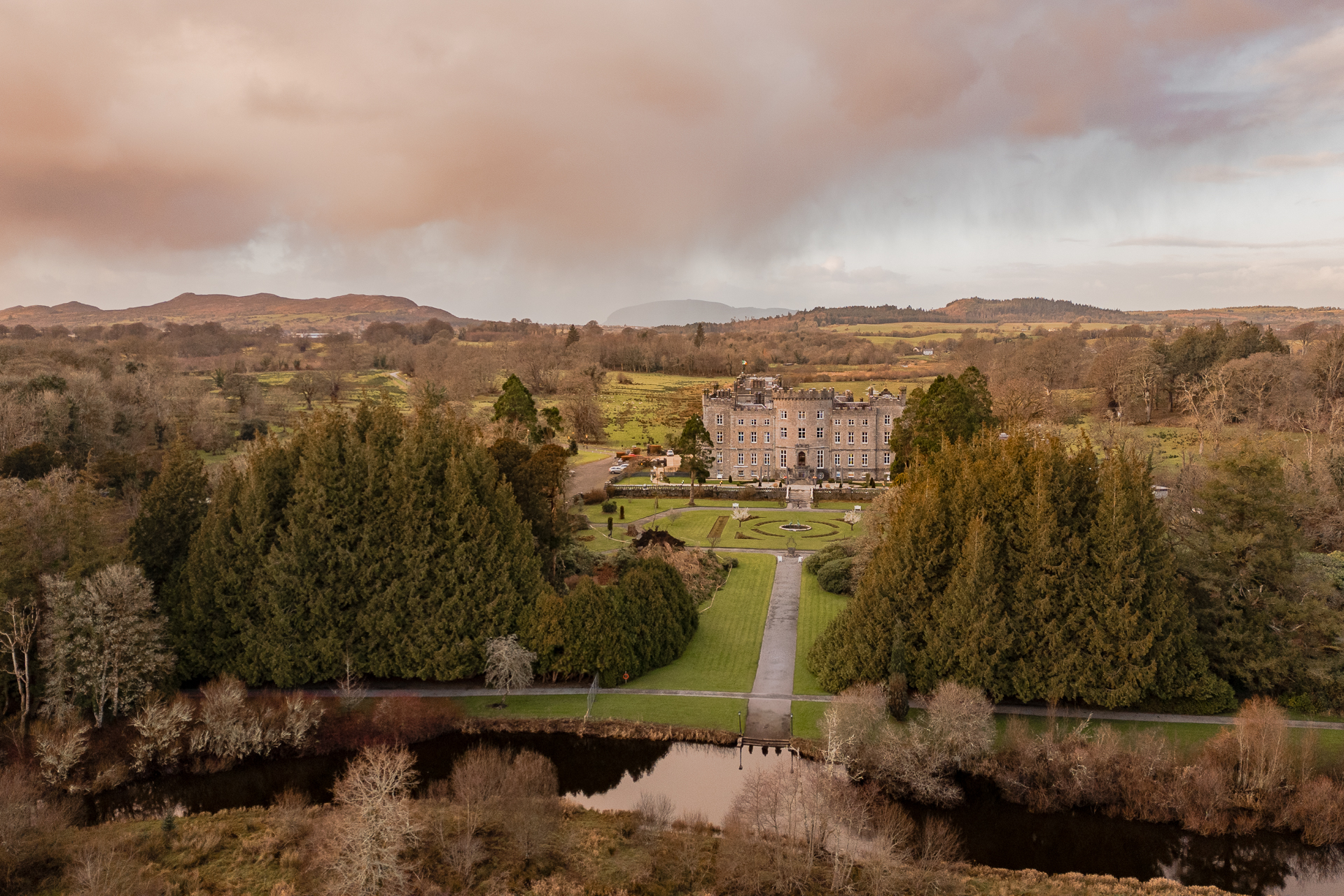 A landscape with trees and a building in the distance